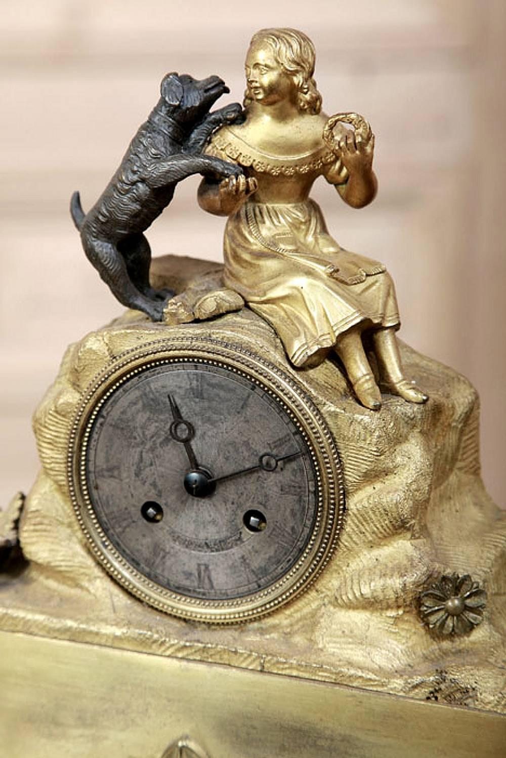 Charming and exquisite is this French gilded bronze mantel clock 