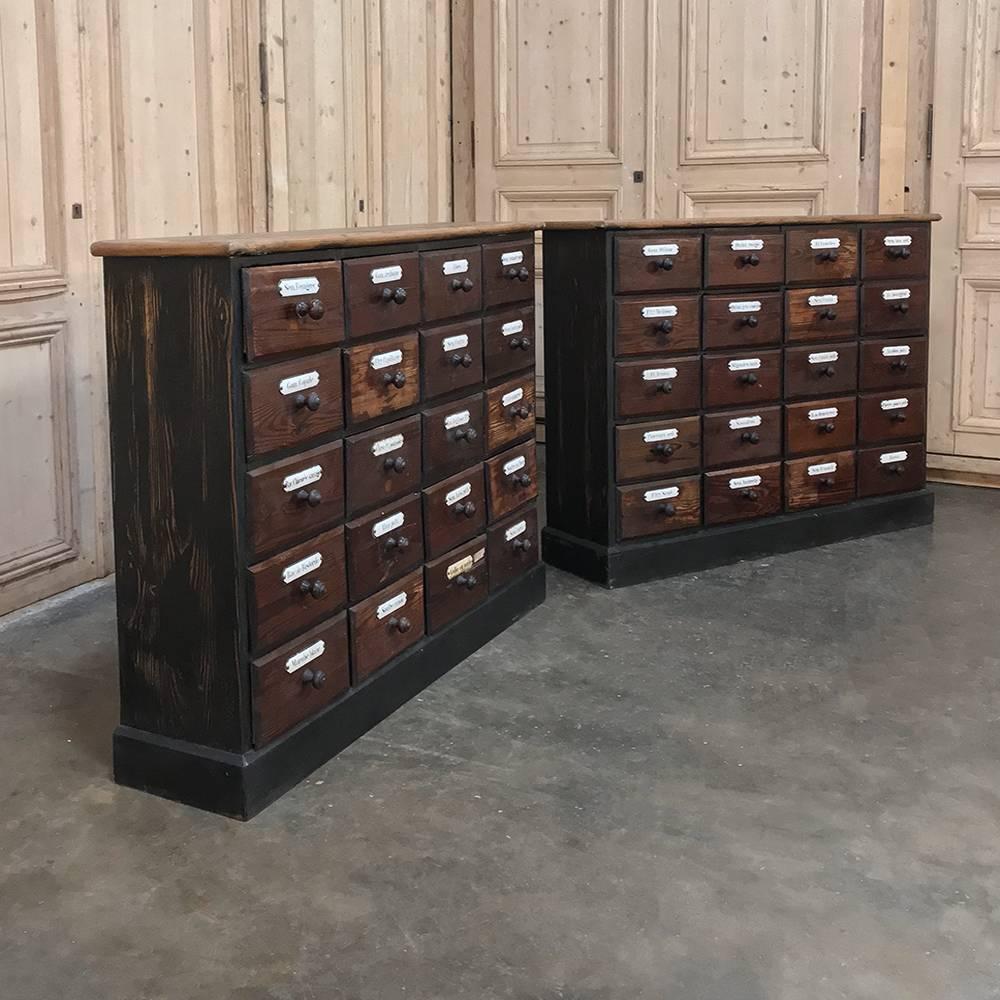 Pair 19th Century French Belgian Pharmacy Cabinets are perfect for adding an eclectic touch to your office, study or game room! This pair was found in old pharmacy and all forty drawers retaining their original enamelled labels are in good condition