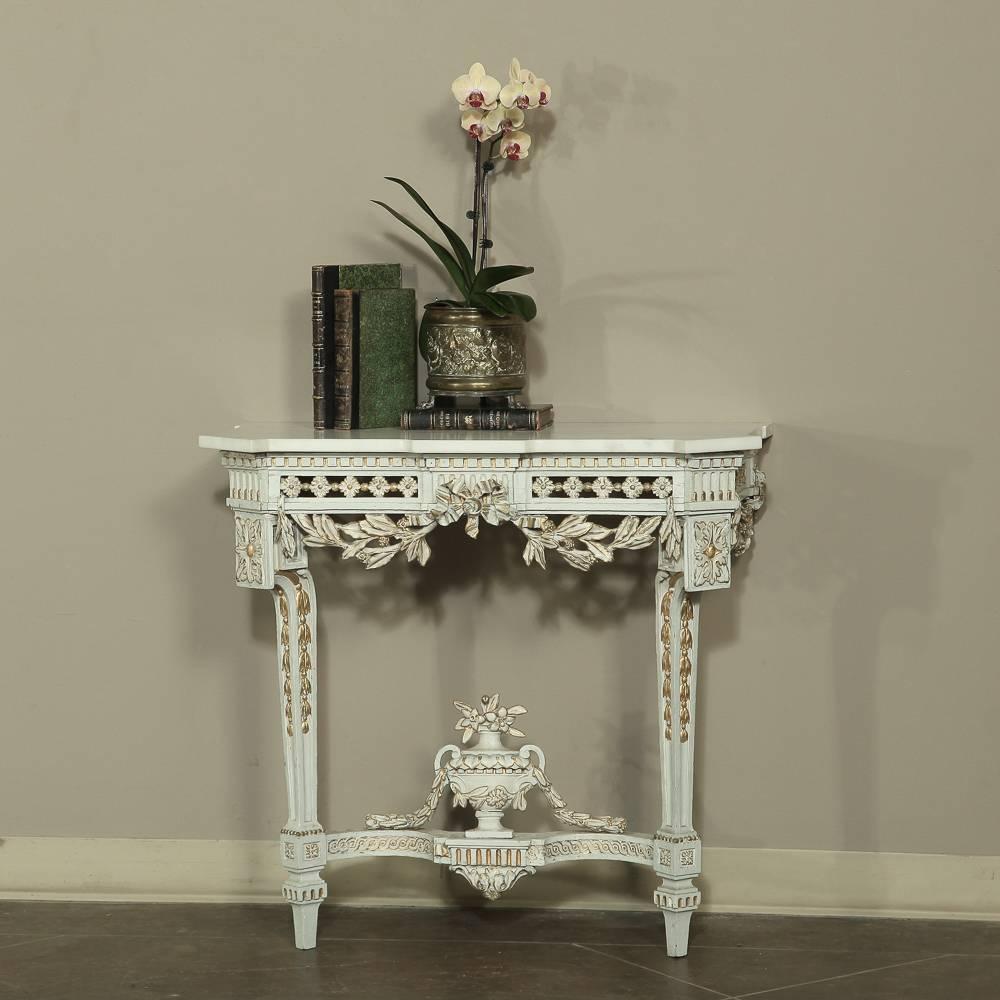 19th century Swedish Neoclassical marble-top painted console features fantastic hand carved detail and pierce-carved elegance with gold highlights, and Carrara marble top.  Motifs include floral, foliate and ribbons accented with laurel sprays, an