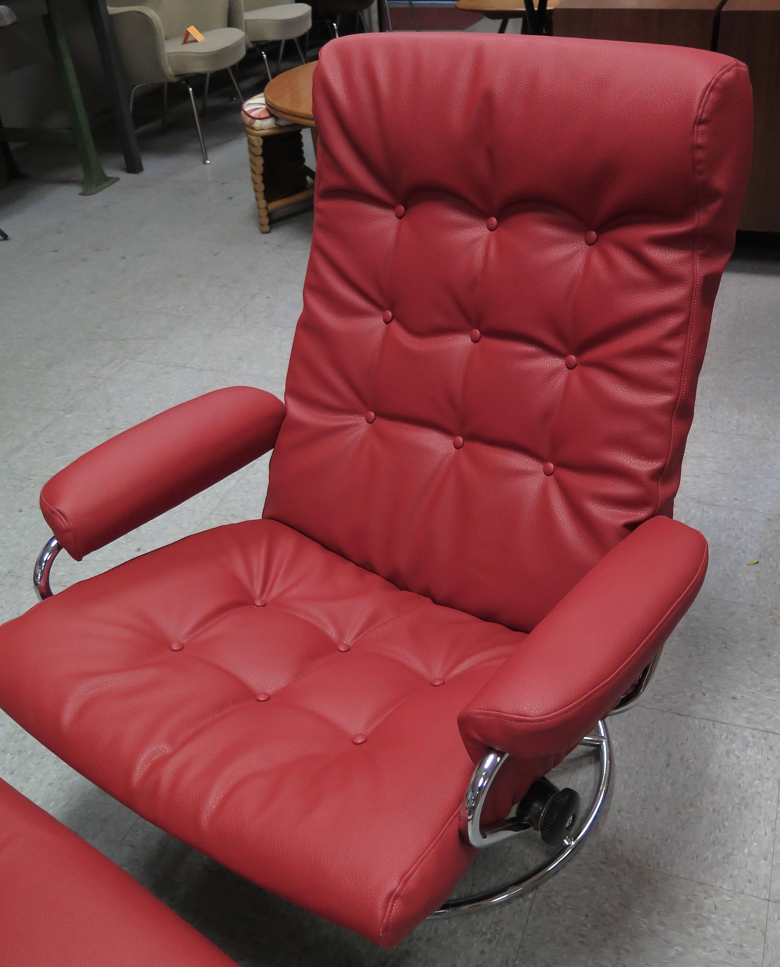 New recycled cranberry color leather. Adjustable handles on side of chair for full recline position. Chrome has some scuffs. Ottoman measures 22 in. x 18 in. x 14.5 in.