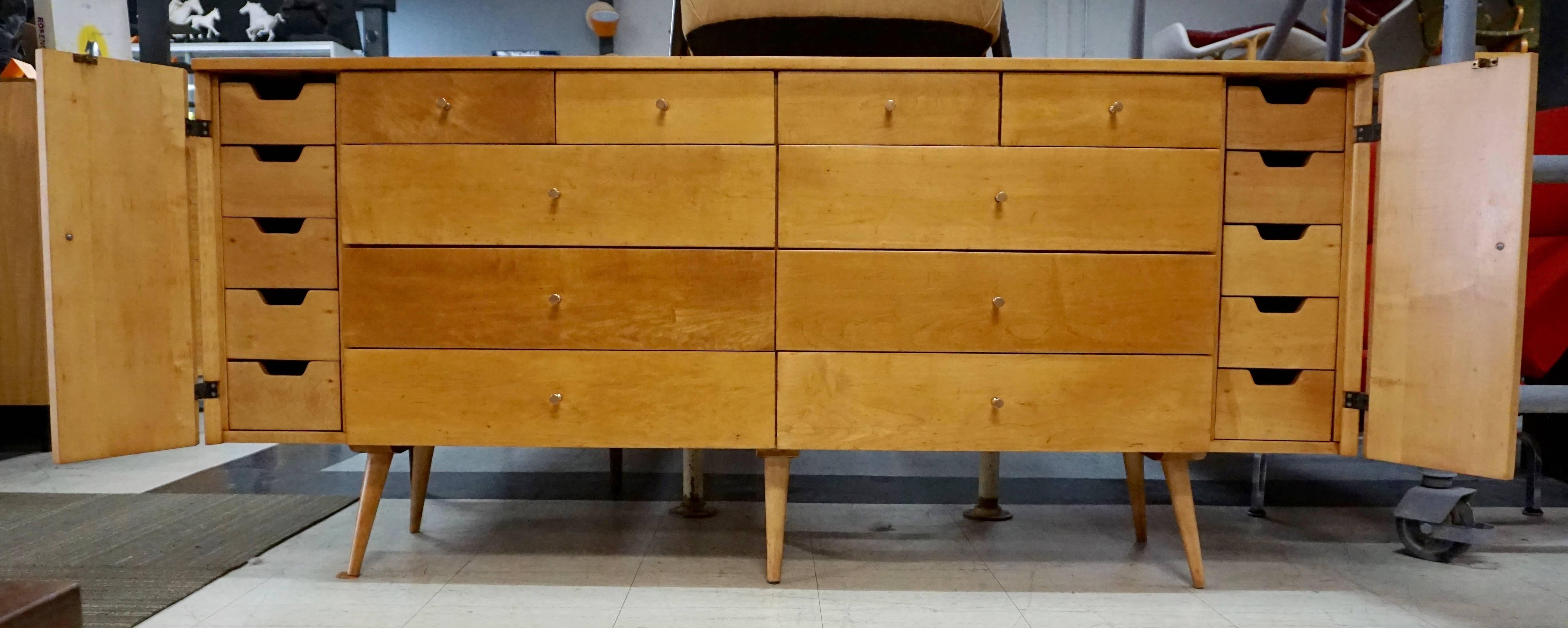 Great solid maple 20-drawer dresser. Has been stripped and lacquered. The knobs are unusual in copper coating. Has a few small imperfections under the new finish, small dark lines and spots, all shown in photos. Unusual coloring on some of the