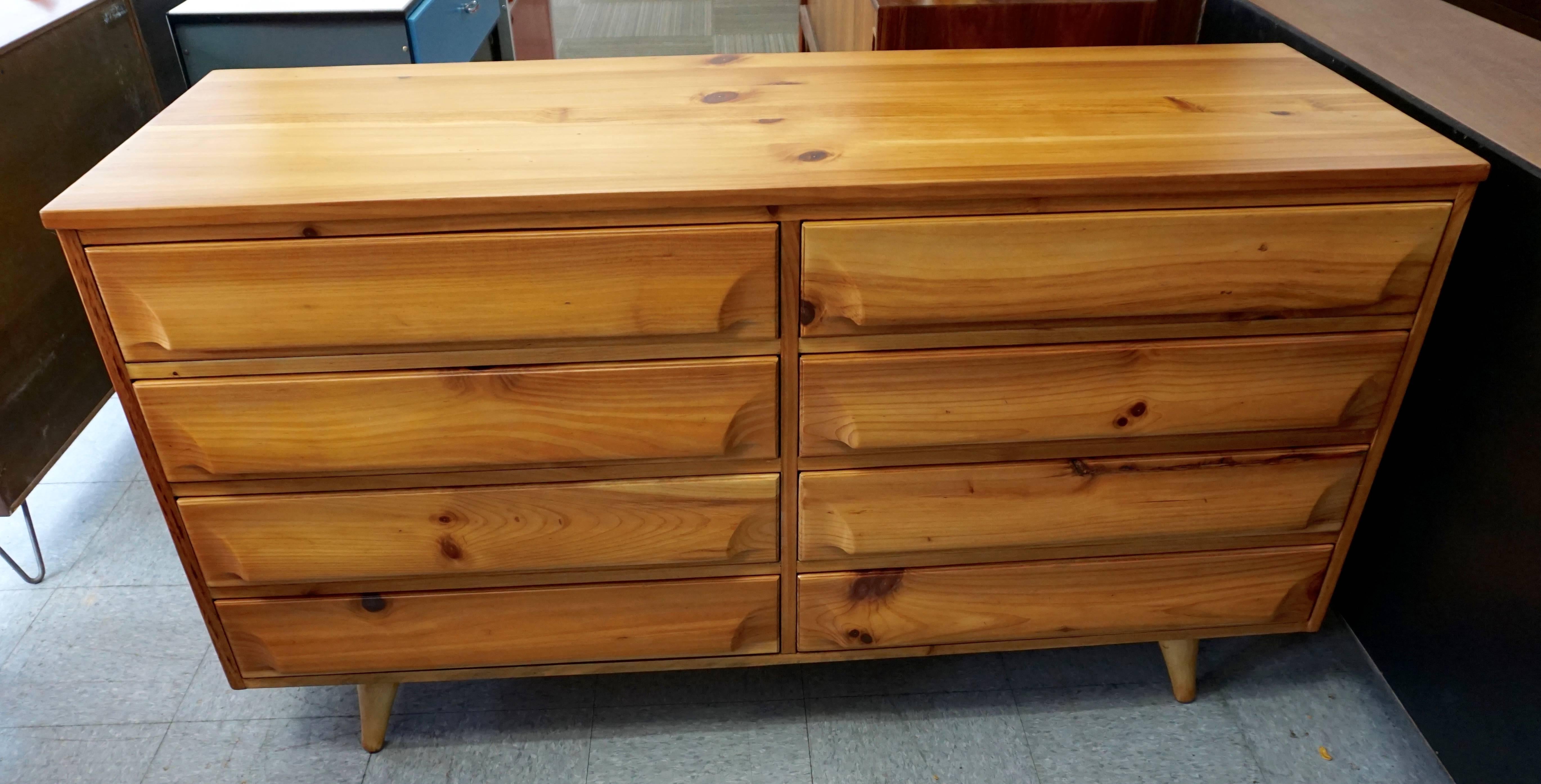 Restored. Labelled. Unusual eight drawer modern pine dresser. Warm color with dark knots. Drawers open smoothly. Few very minor abrasions on surface from normal use.