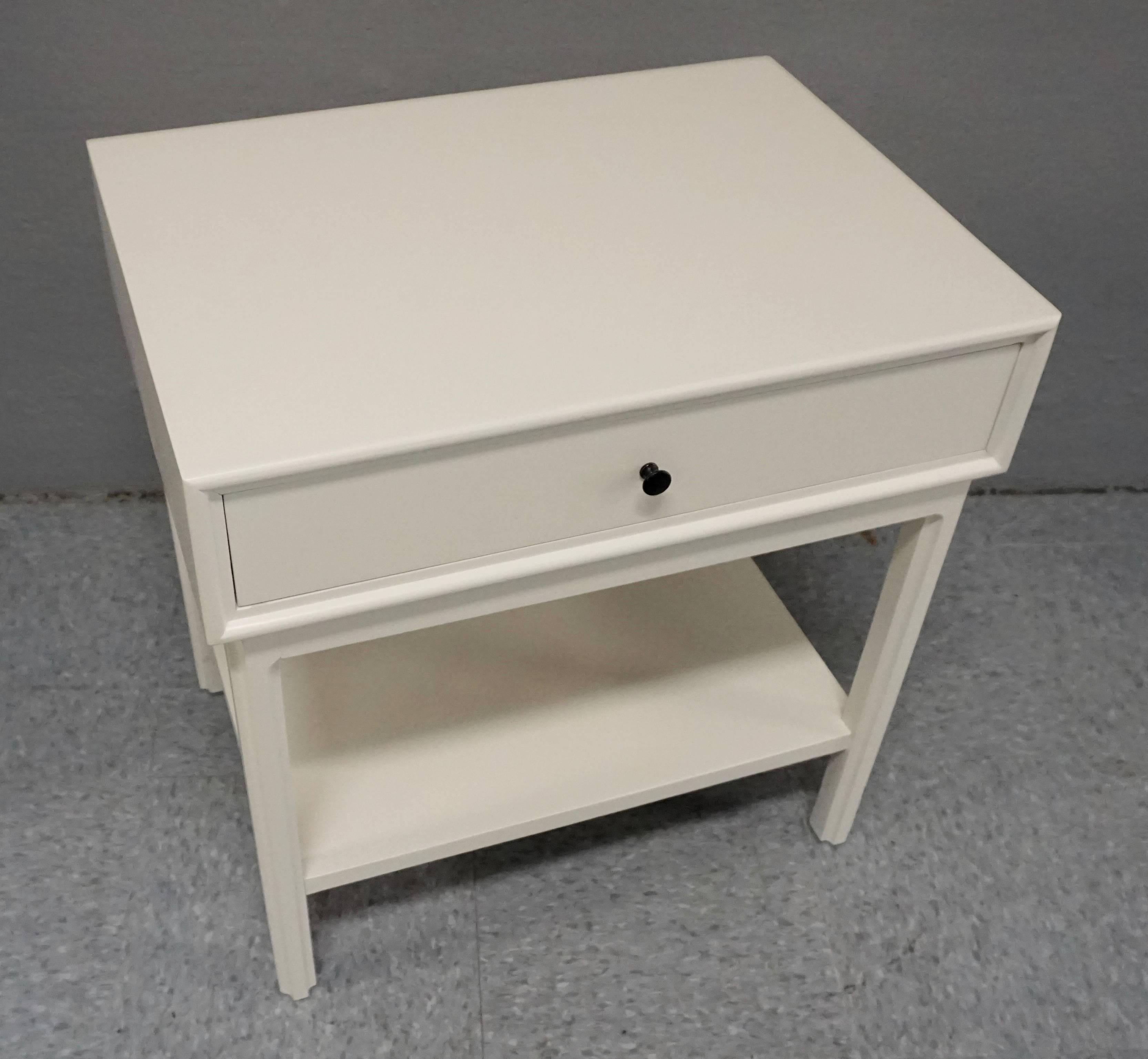 Fresh white lacquer. Heavy construction. Overall great condition, with a few scuffs under the painted surface. Black metal drawer pulls.