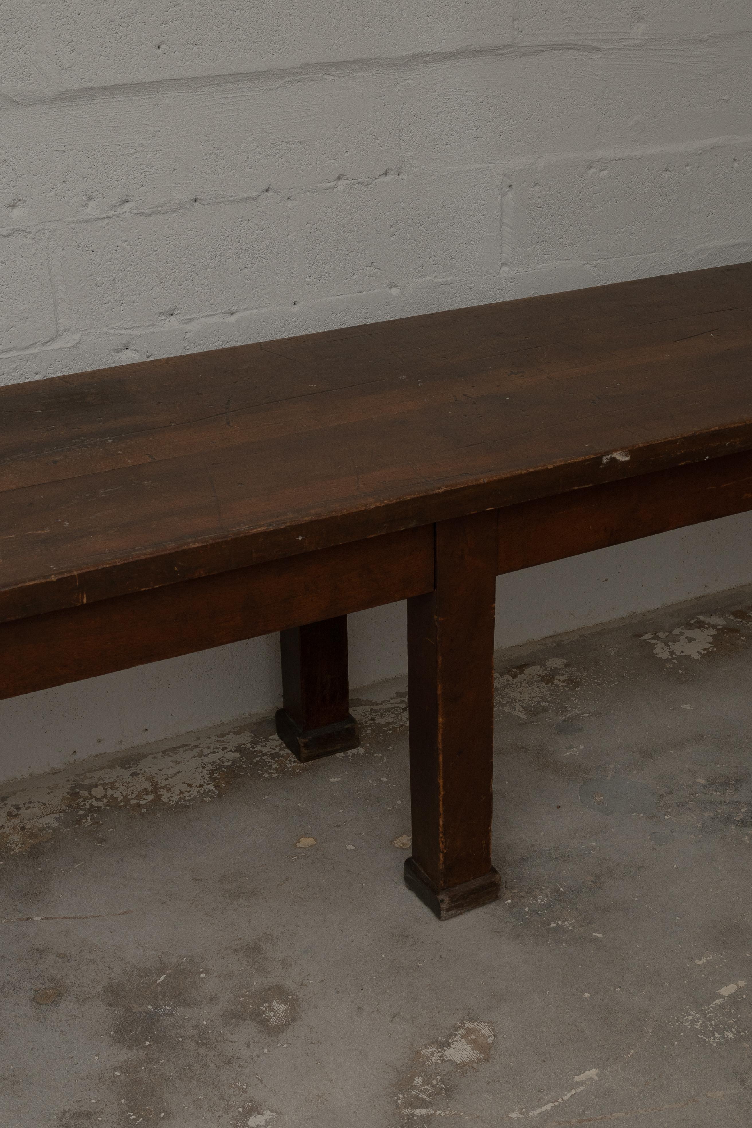 A substantial French provincial work table, circa early 1900s. Crafted from solid wood with a rich, timeworn patina. This piece exemplifies the utilitarian beauty of early 20th-century French craftsmanship. Originally designed for use in a workshop