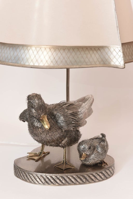 A pair of sterling silver four-piece duck family lamps, made by the workshop of Lisi, with sterling silver hallmarks. The feather meticulously cut and applied to appear life-like. This process is involves sculpting the animals and casting it in