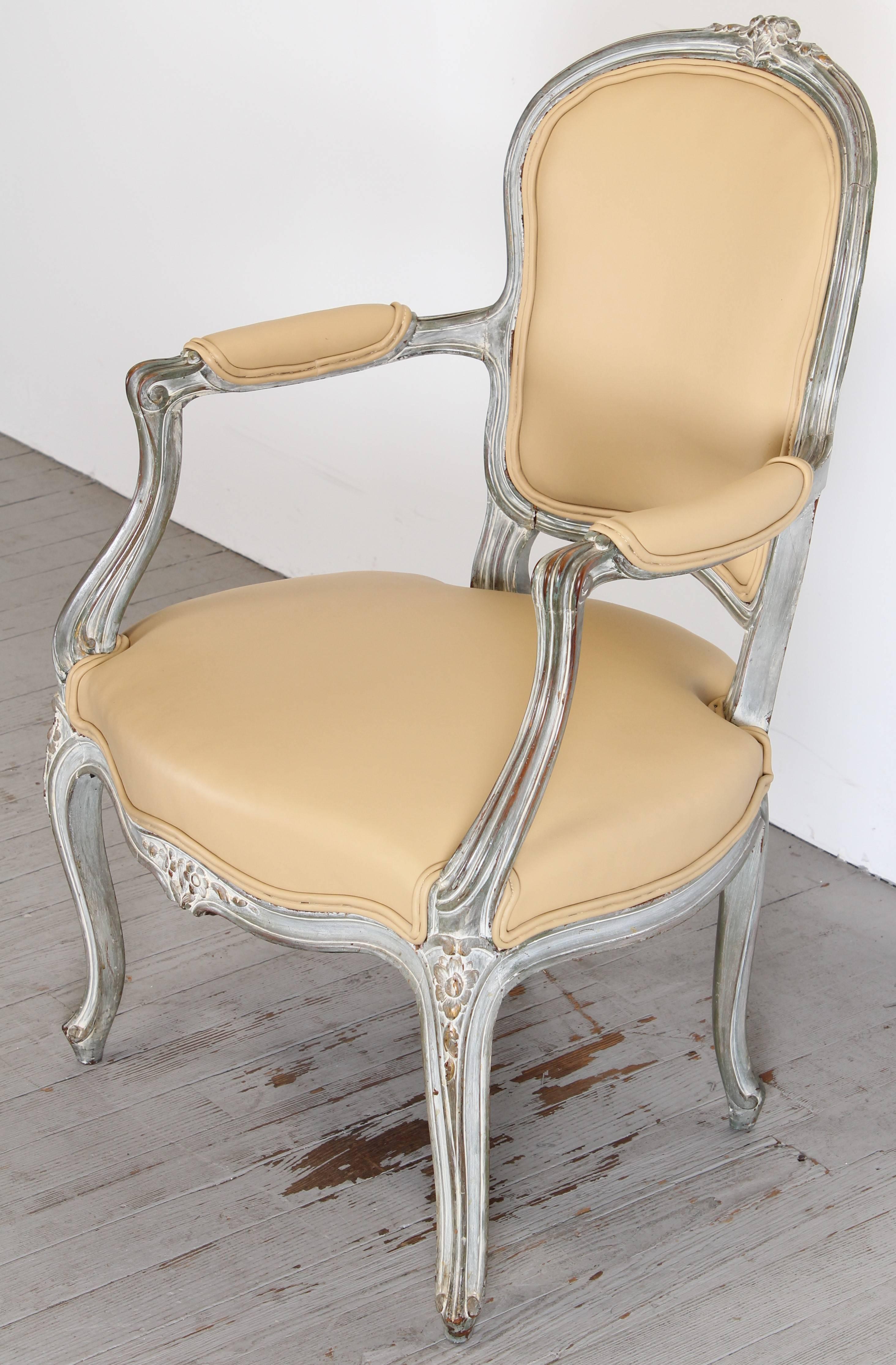 A lovely painted French Louis XV painted beech wood Fauteuil or Armchair. Having a green tinted cream and gray painted finish. The chair is sturdy; the gap in lower left backrest is solid and has no movement. New upholstery is recommended.