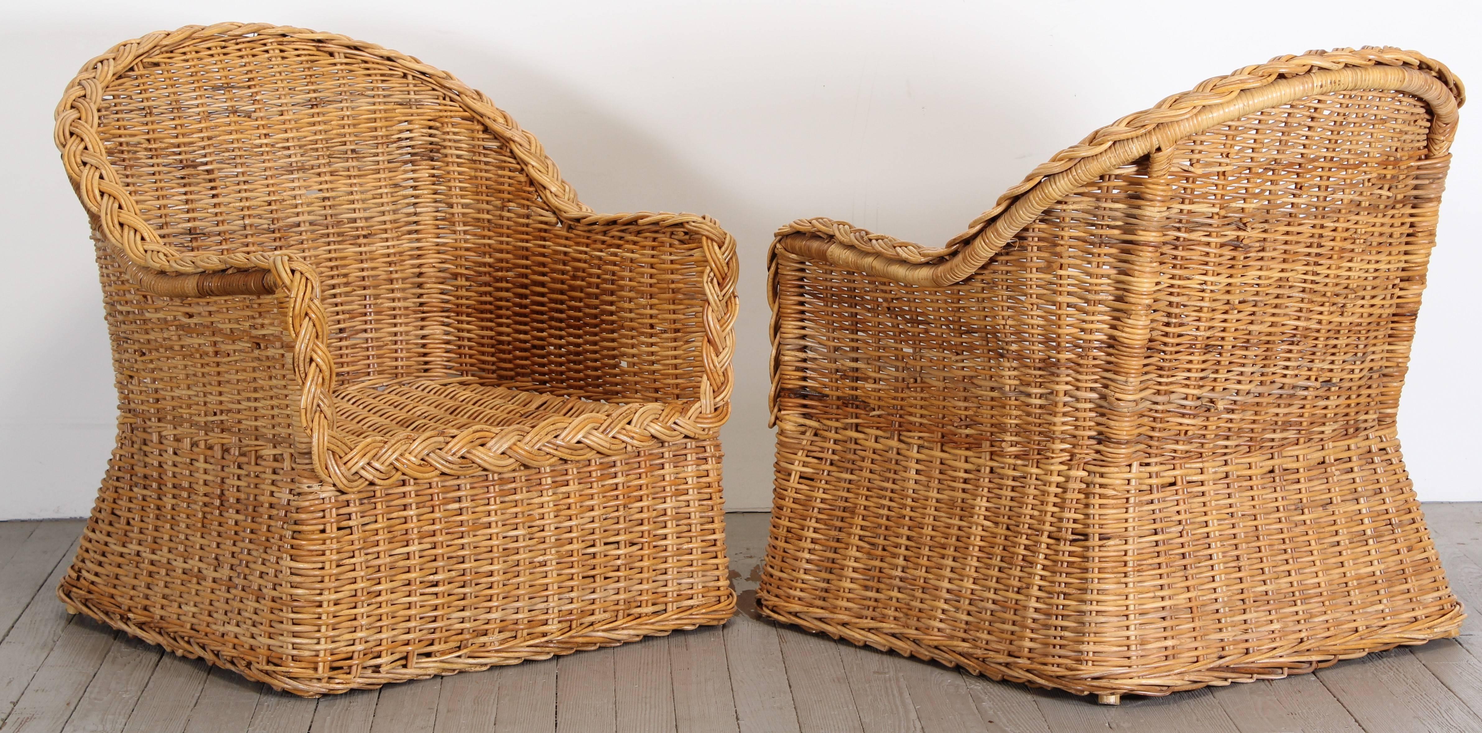 A fabulous pair of wicker armchairs, circa 1960. The solid foam cushions are included for both chairs, however they need to be reupholstered. These will look great in an enclosed patio, sun room or any modern or traditional home.