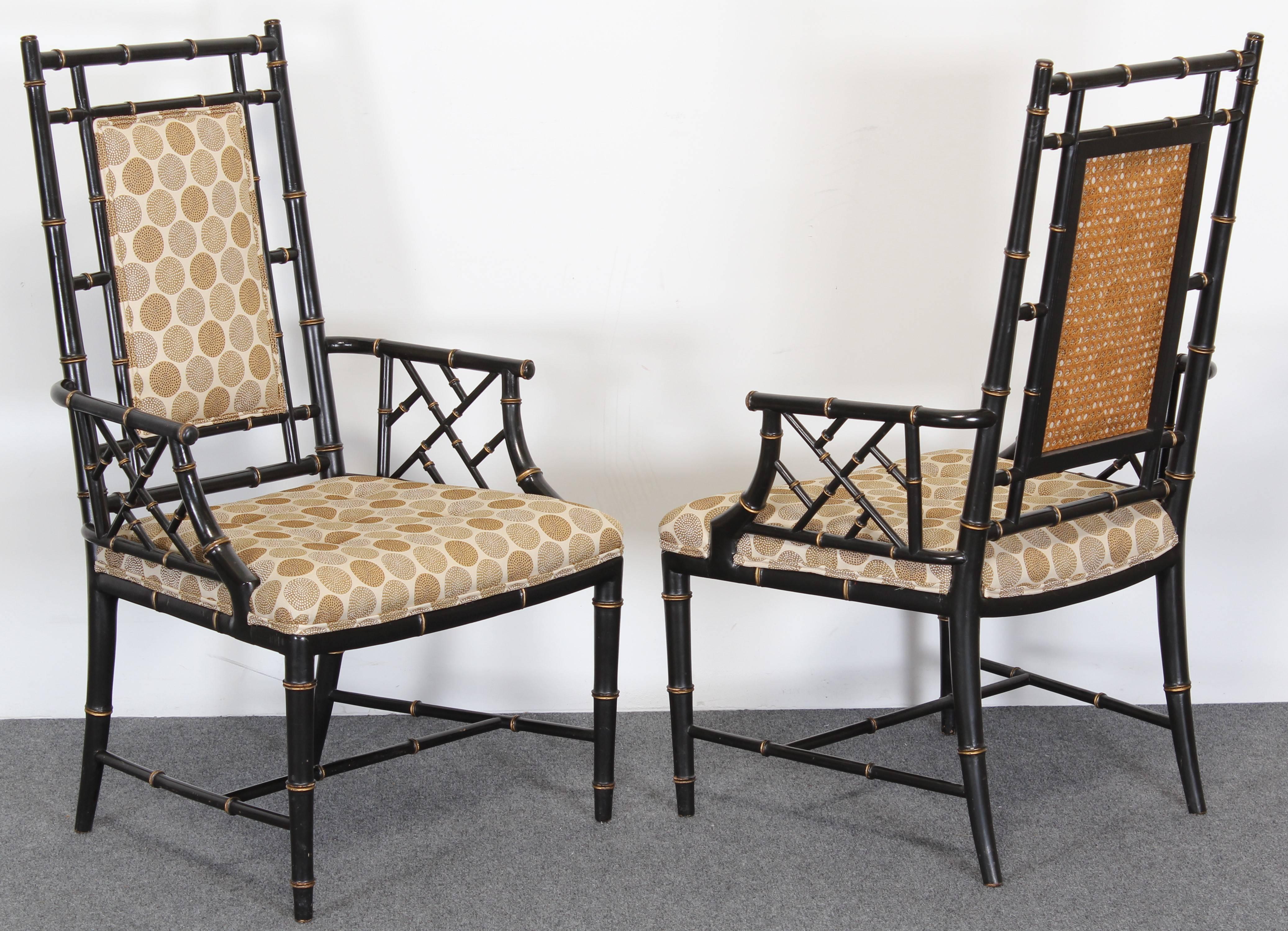 Pair of elegant ebonized faux bamboo chairs with gold accents and cane backs. Originally circa 1960 and more recently upholstered. Very good condition with age appropriate wear as shown in images.