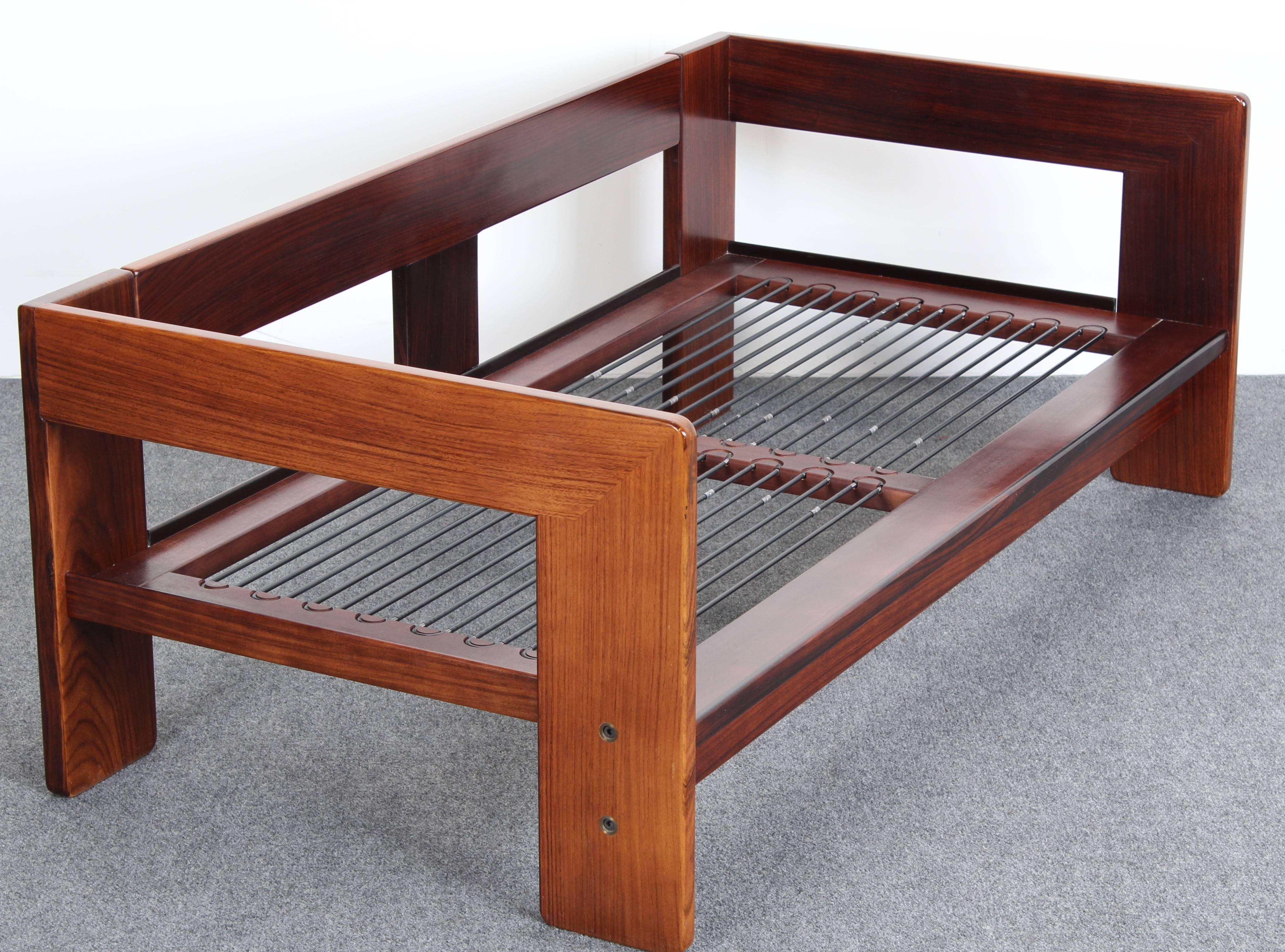 A Knoll solid rosewood "Bastiano" settee frame designed by Tobia Scarpa. Requires new cushions. Some fading to sides of settee. Frame is in good condition.