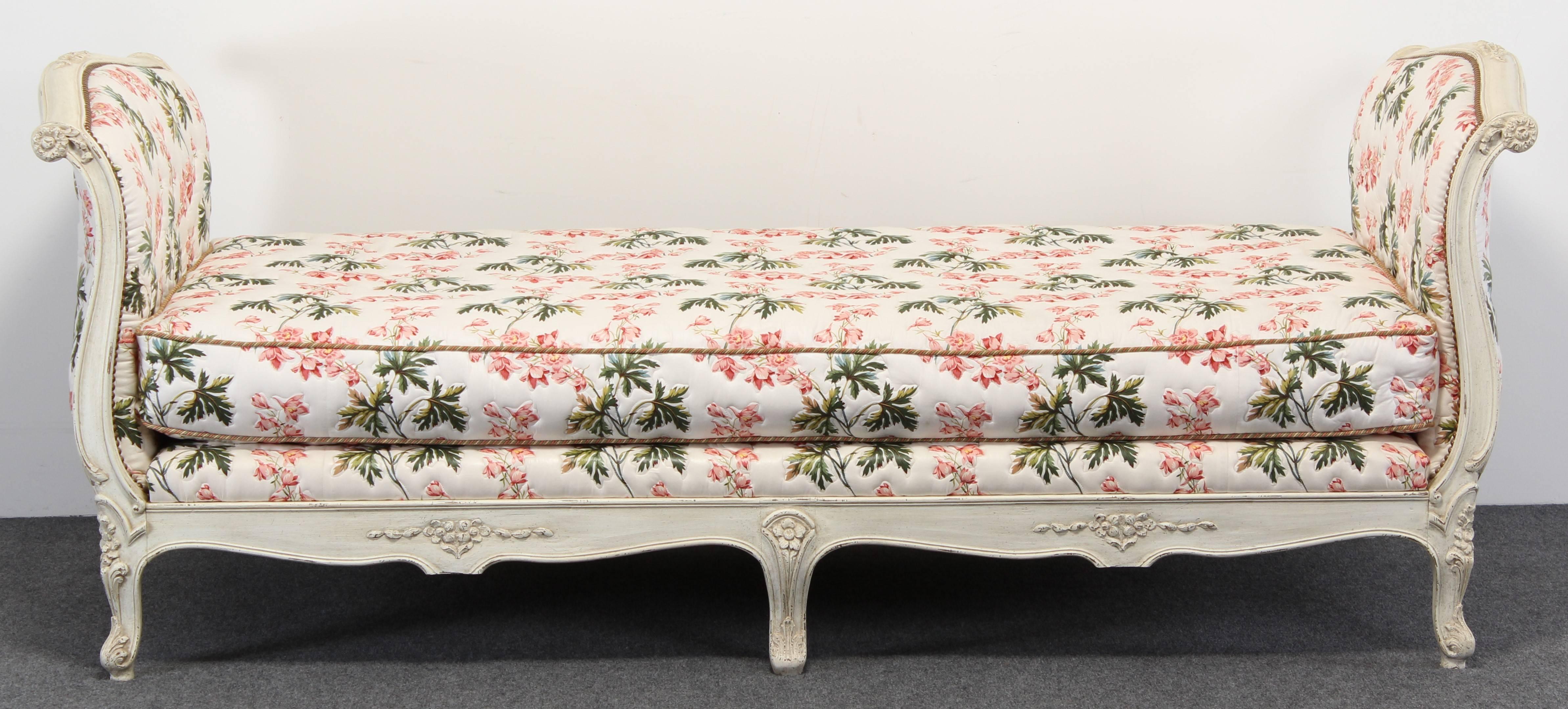 A handsome French Louis XV style carved wood daybed with original paint and Chintz floral fabric. Structurally sound. Fabric is in good condition.
 