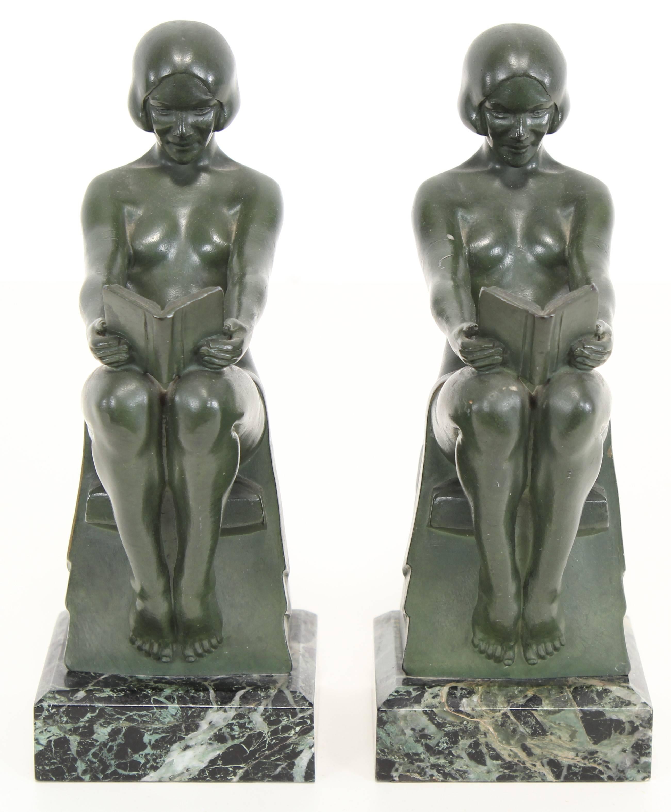 A fabulous pair of Art Deco nude bookends signed by French artist Max Le Verrier. Original bronze toned Verdi green finish on a variegated marble base. They are in very good condition. Slight wear to finish on one arm, as shown in images.