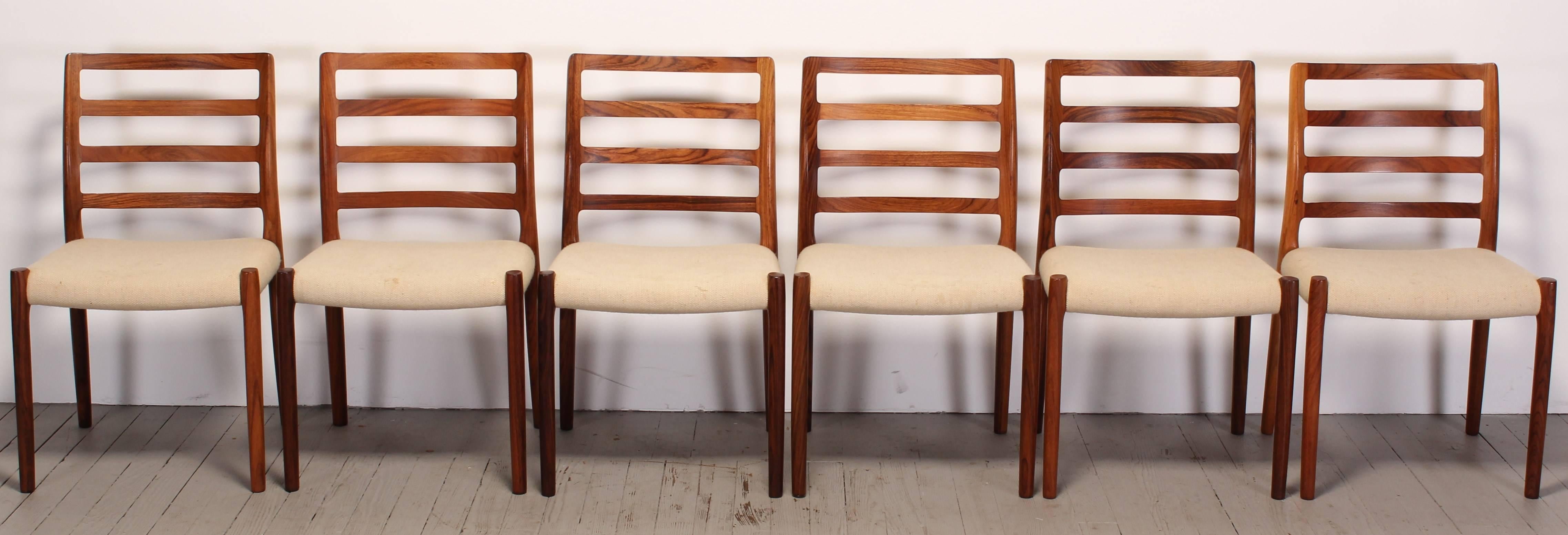 A  fine set of six rosewood dining chairs by Niels O. Møller for J.L. Moller.  The model 85 chair is one of Moller's stoutest designs in their large variety of chair designs, well constructed chairs with great form. Designed in 1981, labeled