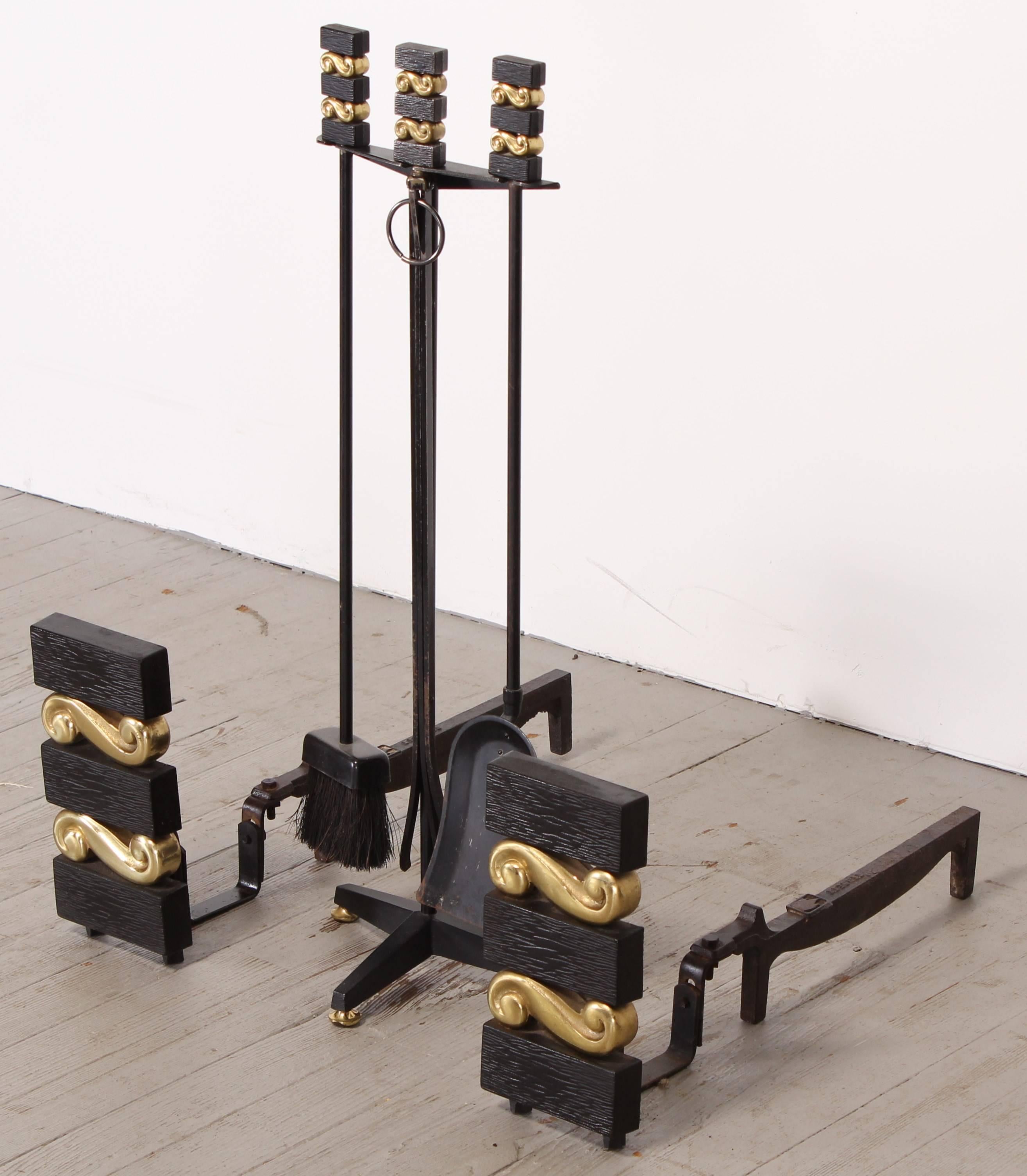 A set of modern iron and brass Donald Deskey style for Bennett Co., andirons and fireplace tools, 1940. The set has it's original finish. The andirons are 11.5" Tall, 5.5" Wide, 23.5" Deep. The tools and stand together are