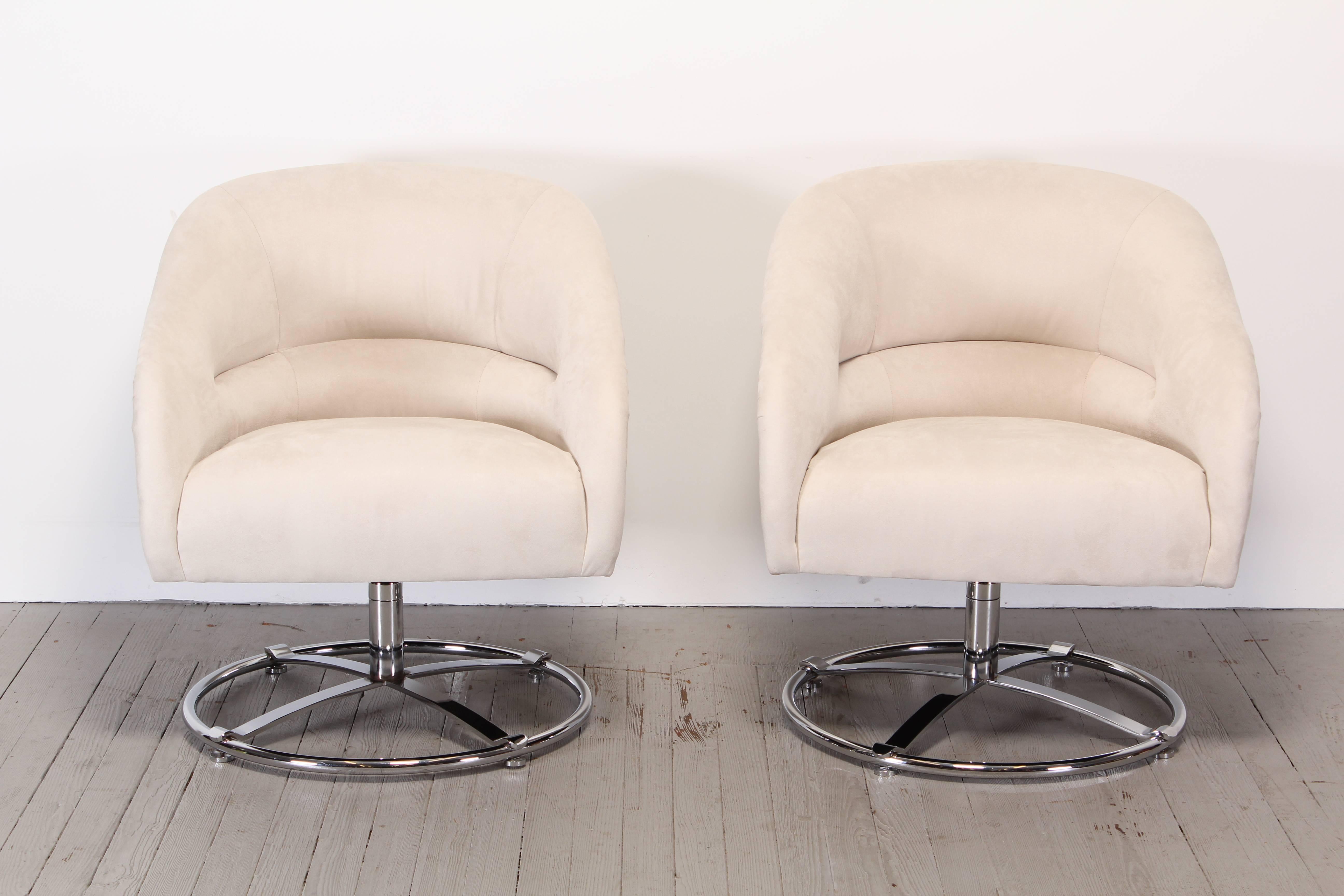 A pair of large scale chromed steel swivel chairs by Ward Bennett, 1970. Upholstered in luxurious ultra-suede fabric. 
  