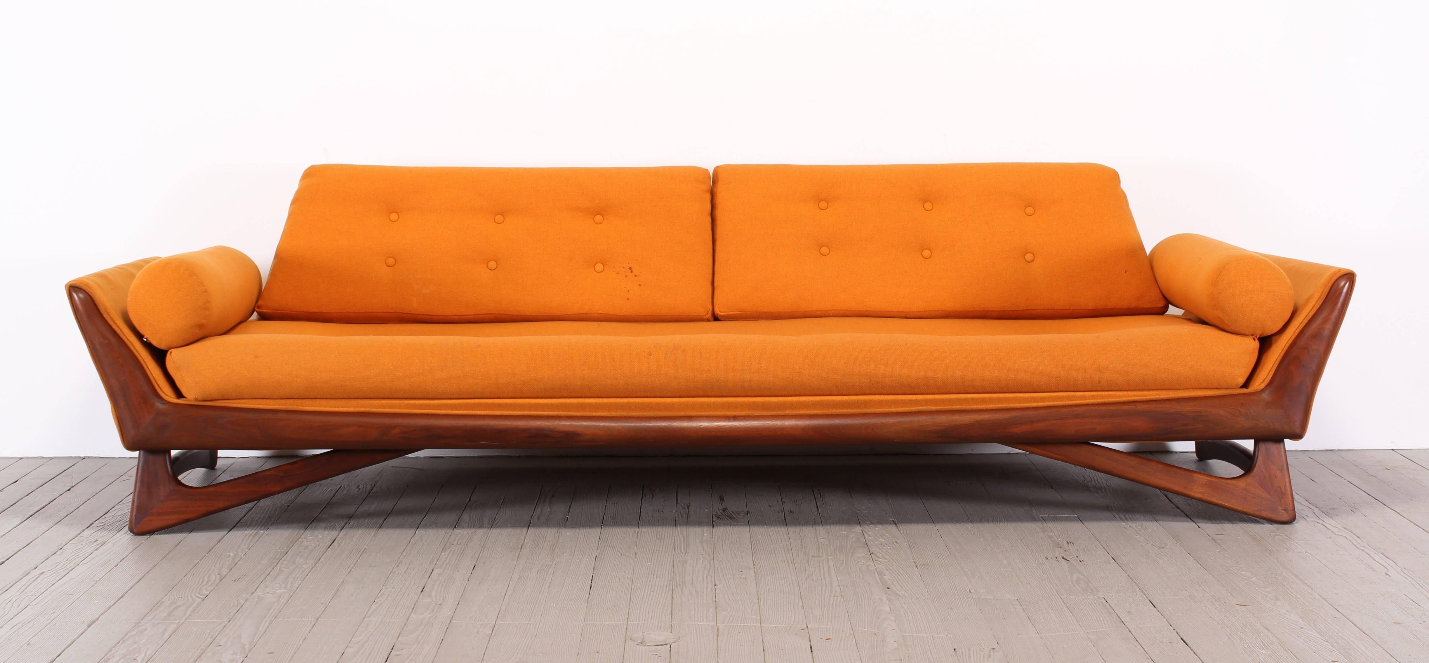 A sculptural Adrian Pearsall sofa for Craft Associates, 1960. This is an unusual model with walnut base. New upholstery necessary. Some joints are loose which is normal age appropriate wear from usage. Can be glued upon re-upholstery. Seat depth