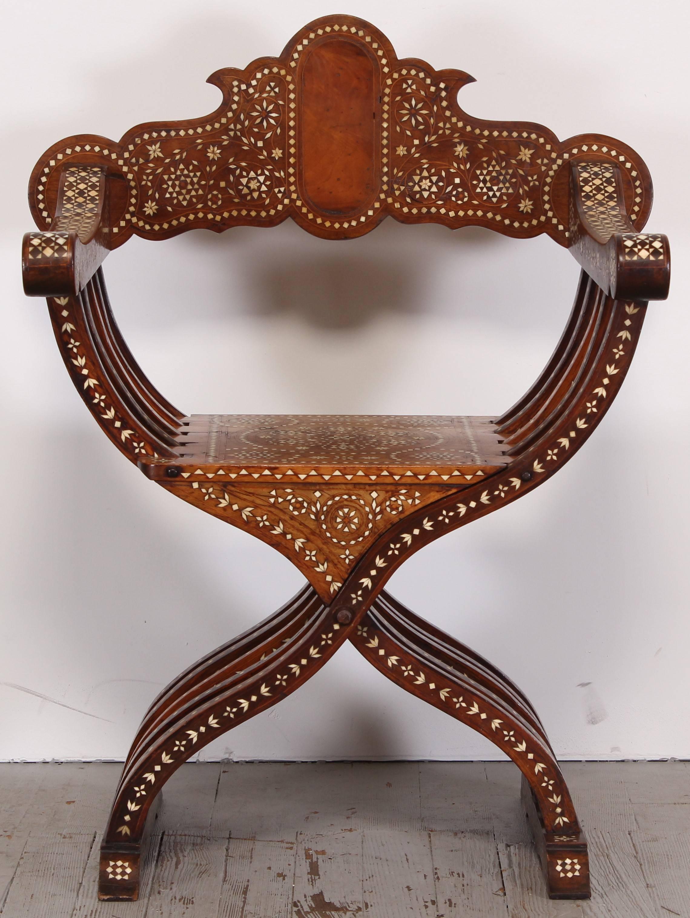 A late 19th century Italian walnut Savonarola chair with inlaid bone patterns.