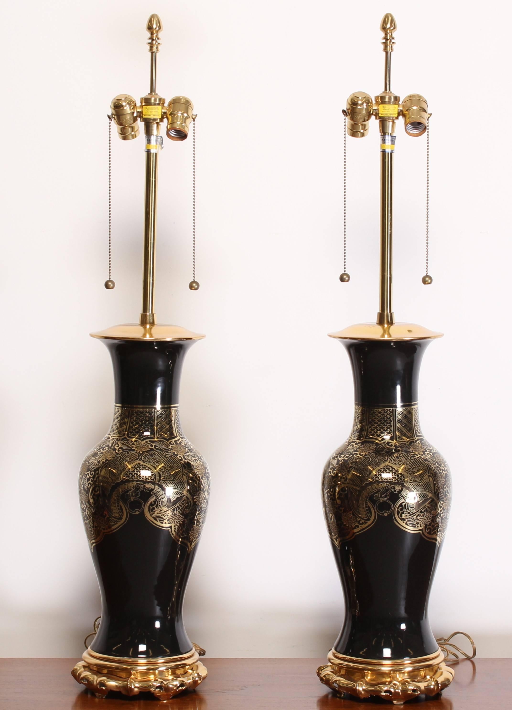 Pair of gilt decorated porcelain body lamps with solid brass mounts and better quality Leviton sockets. Original wiring, which appears to be in good condition.