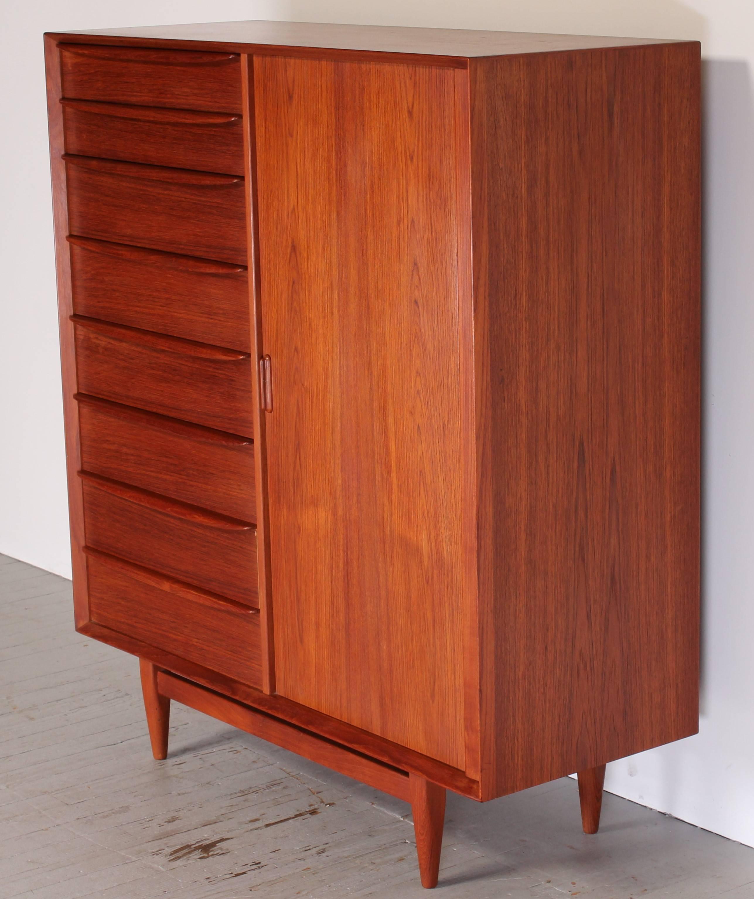 A Svend Madsen for Falster Danish teak tall chest with sculpted drawer pulls and sliding tambour door with birch interior.