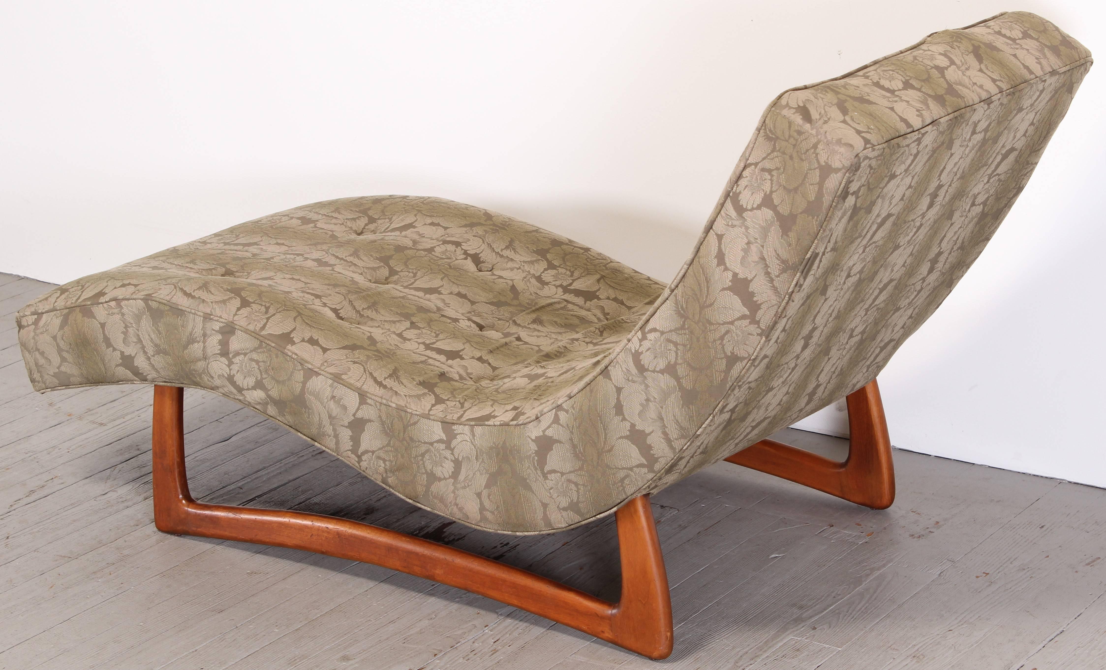 A Mid-Century Modern wave form chaise. Base probably walnut, upholstery is good except for about a 2 inch tear in fabric at the seam as show in images at the top of the chaise. Foam is soft no odors. 