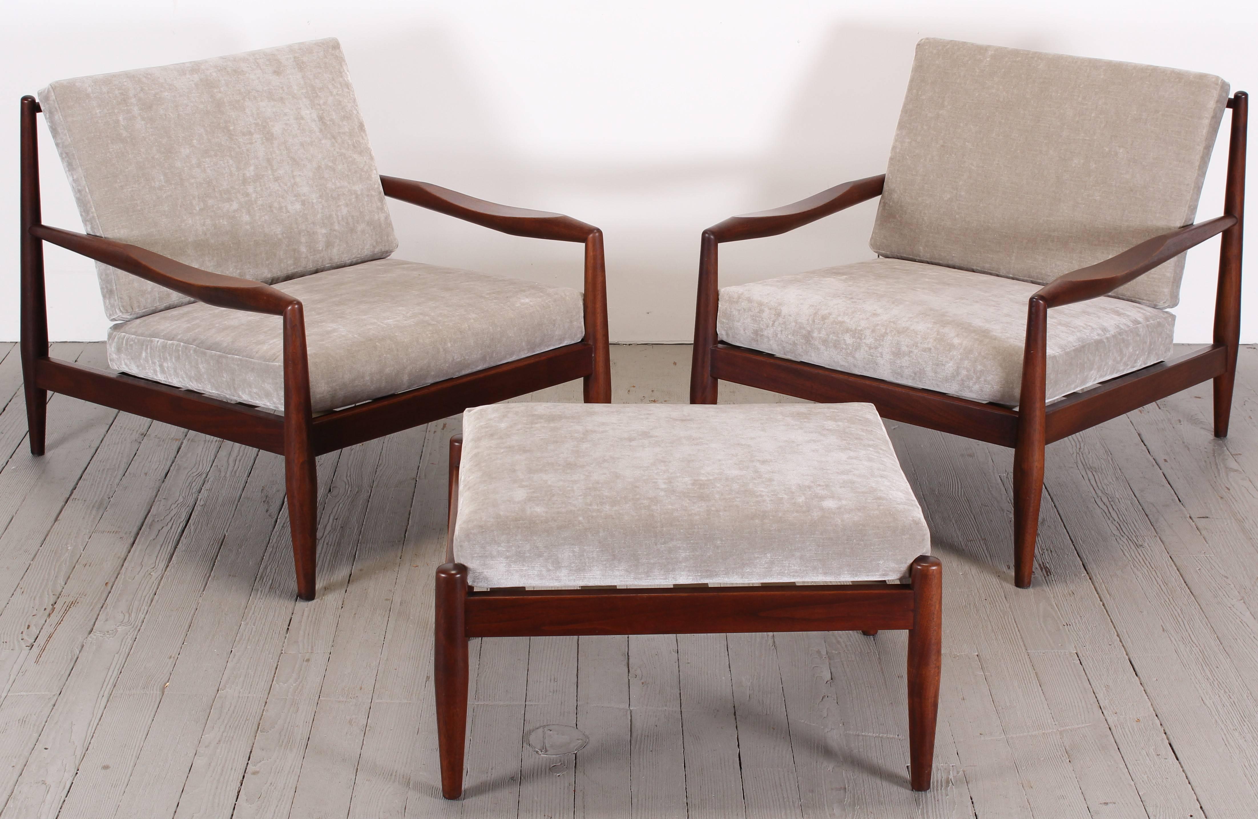A pair of walnut Craft Associates lounge chairs and a single ottoman, designed by Adrian Pearsall. Newly upholstered, new foam, new Perilli straps, in a grey velvet by Pindler and Pindler.