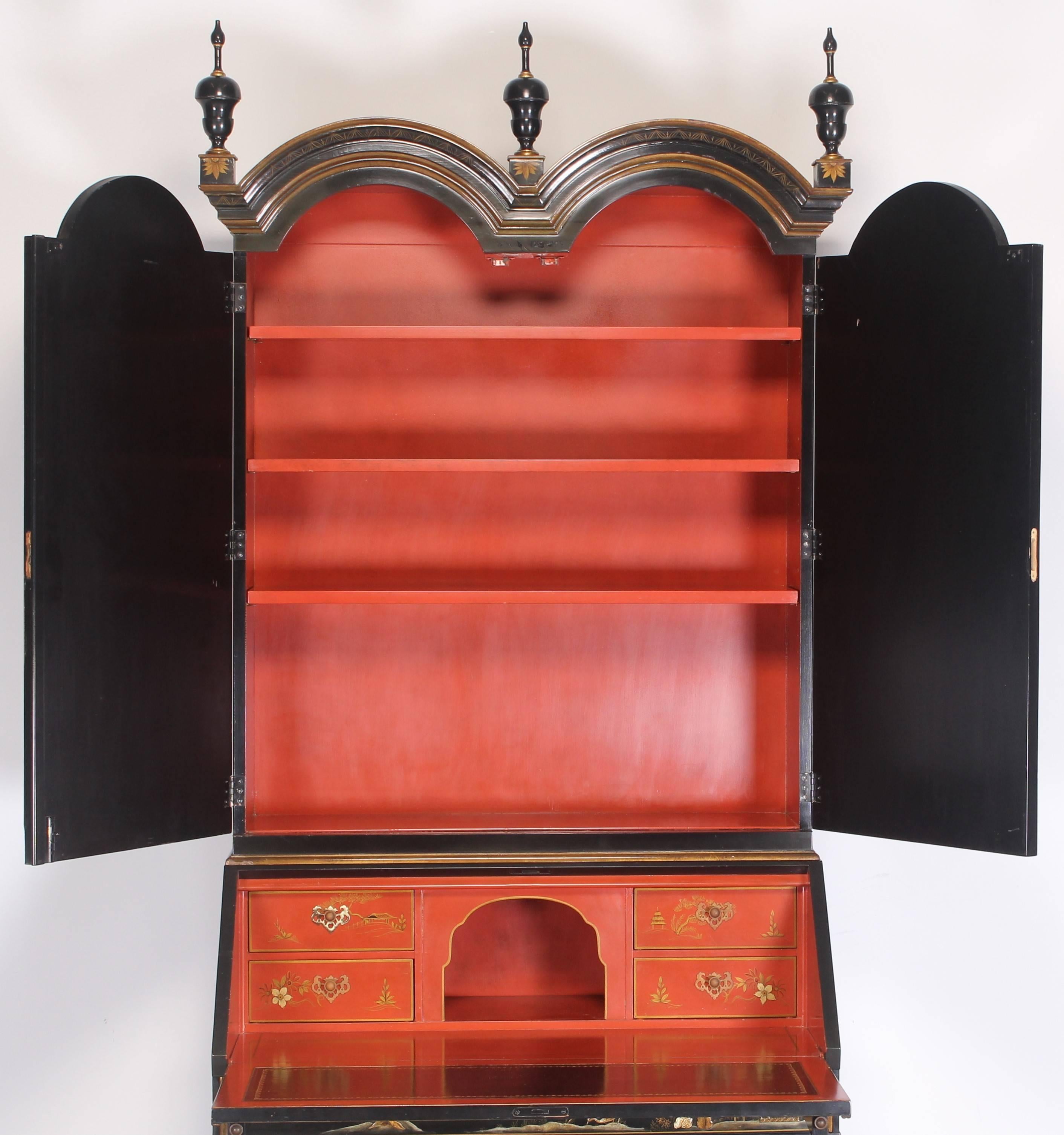 A Baker two-piece chinoiserie black secretary in the Chippendale Style.
