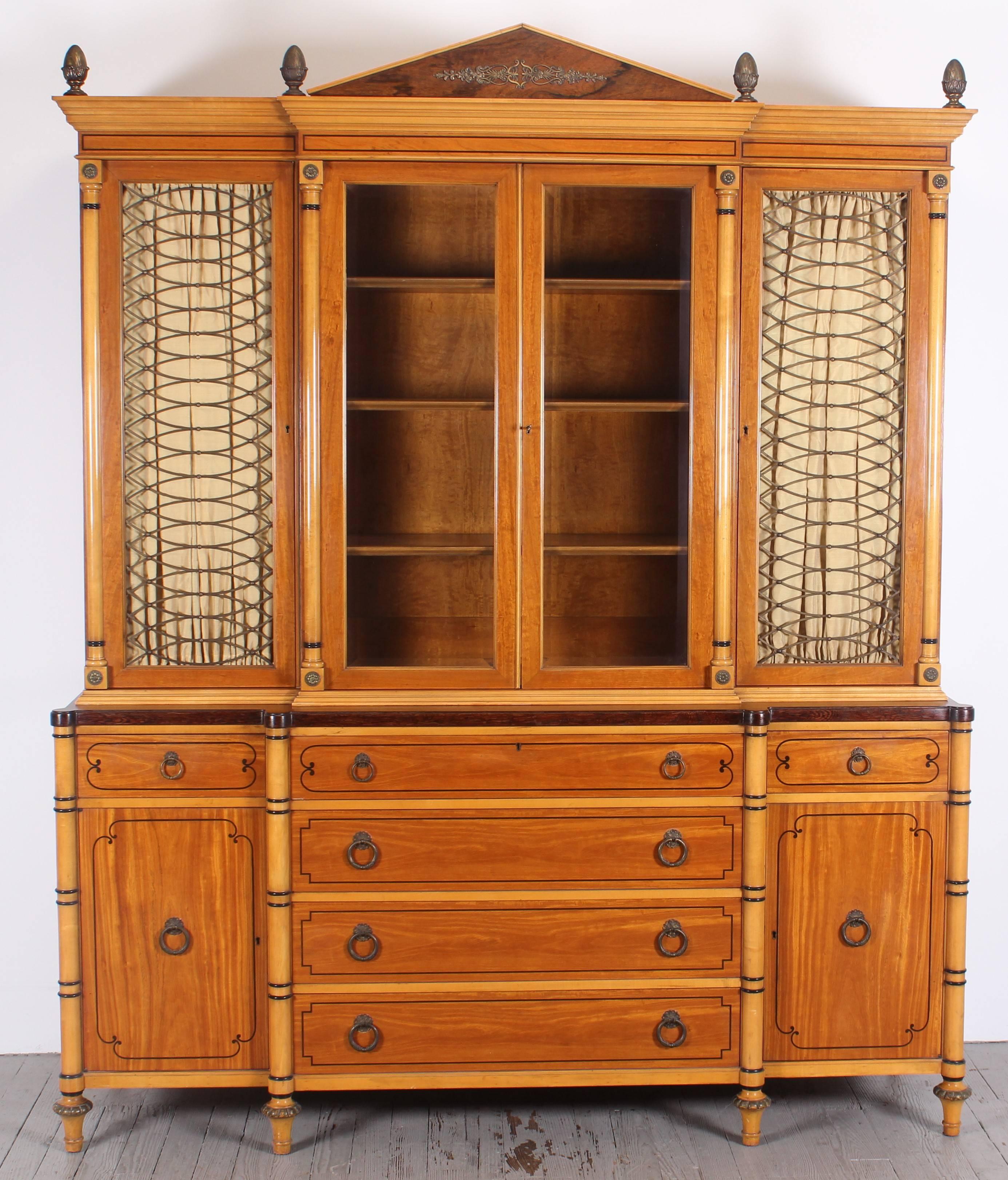 Kittinger two-piece neoclassical cabinet, beveled glass center doors, solid brass artichokes, other solid brass details. Satinwood, rosewood, ebonized inlay door and drawer inlays, ebonized paint details, shows Biedermeier influences One of the most
