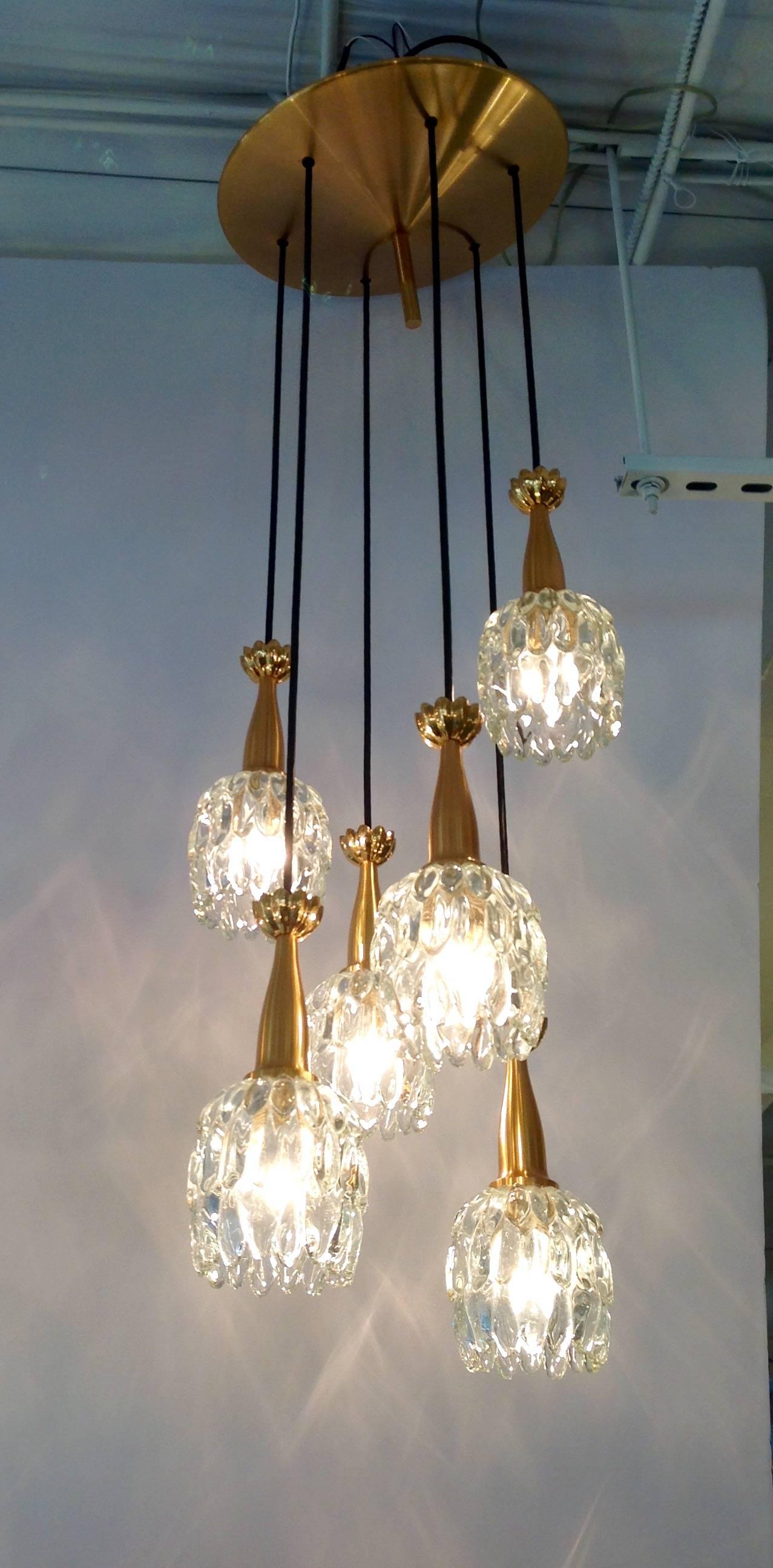 Vintage Kalmar six-light chandelier with adjustable height. The six tulip shaped globes with gold plated brass fittings are on adjustable cable attached to a gold plated disc top. Made in Austria in the 1960s.