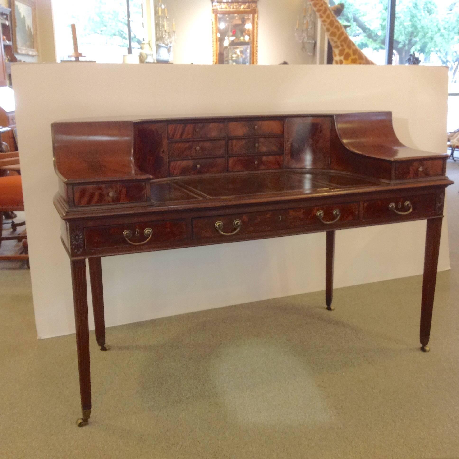 Free standing English Carlton House mahogany desk with fully finished back. It measures 60" wide. The interior work surface is 37" wide and almost 21" deep, circa early 1800s.
