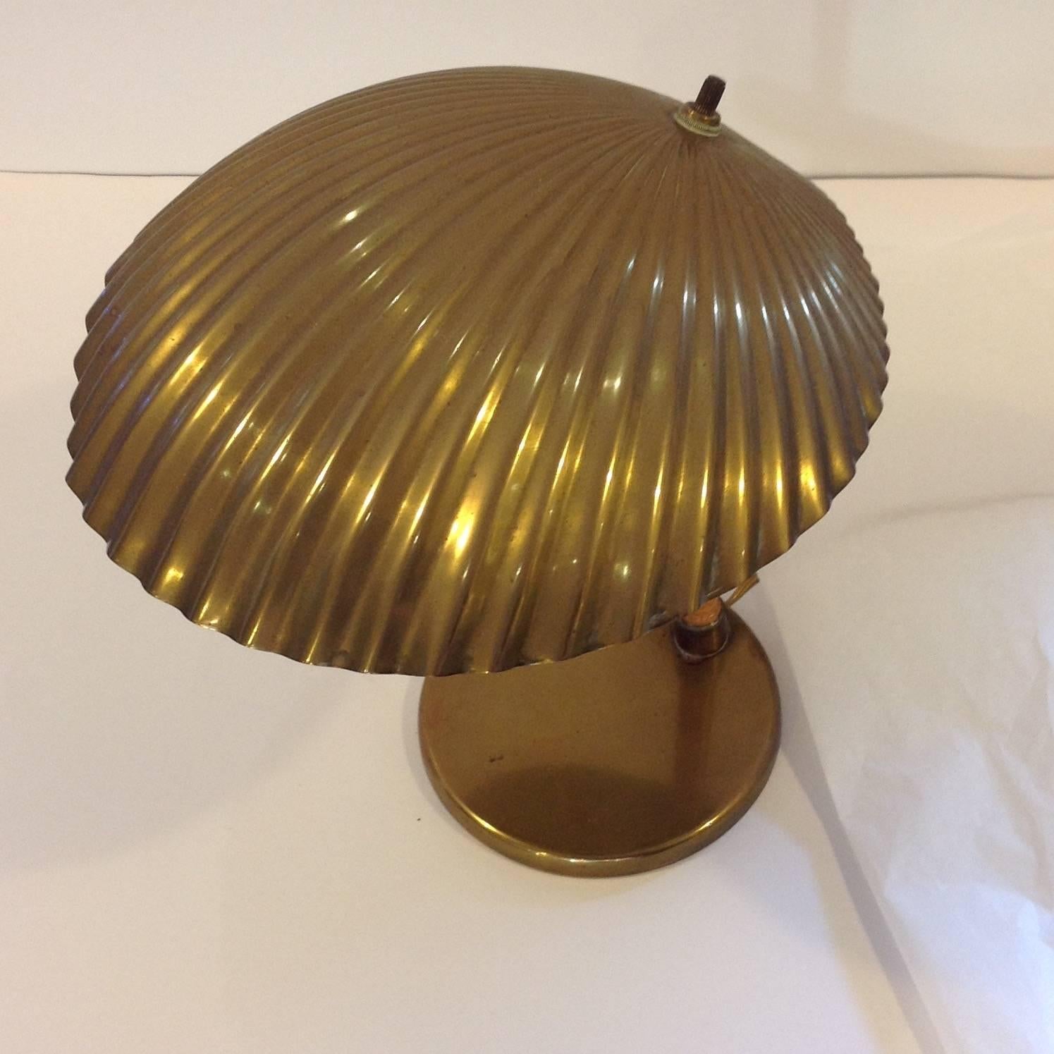 Desk lamp with brass clam shell shade and rattan pole, designed by Paavo Tynell. Made in Finland and manufactured by Taito Oy. It was designed in 1938. The base is marked TT Oy Taito AB 5321.
Made in Finland, circa 1940s.

 