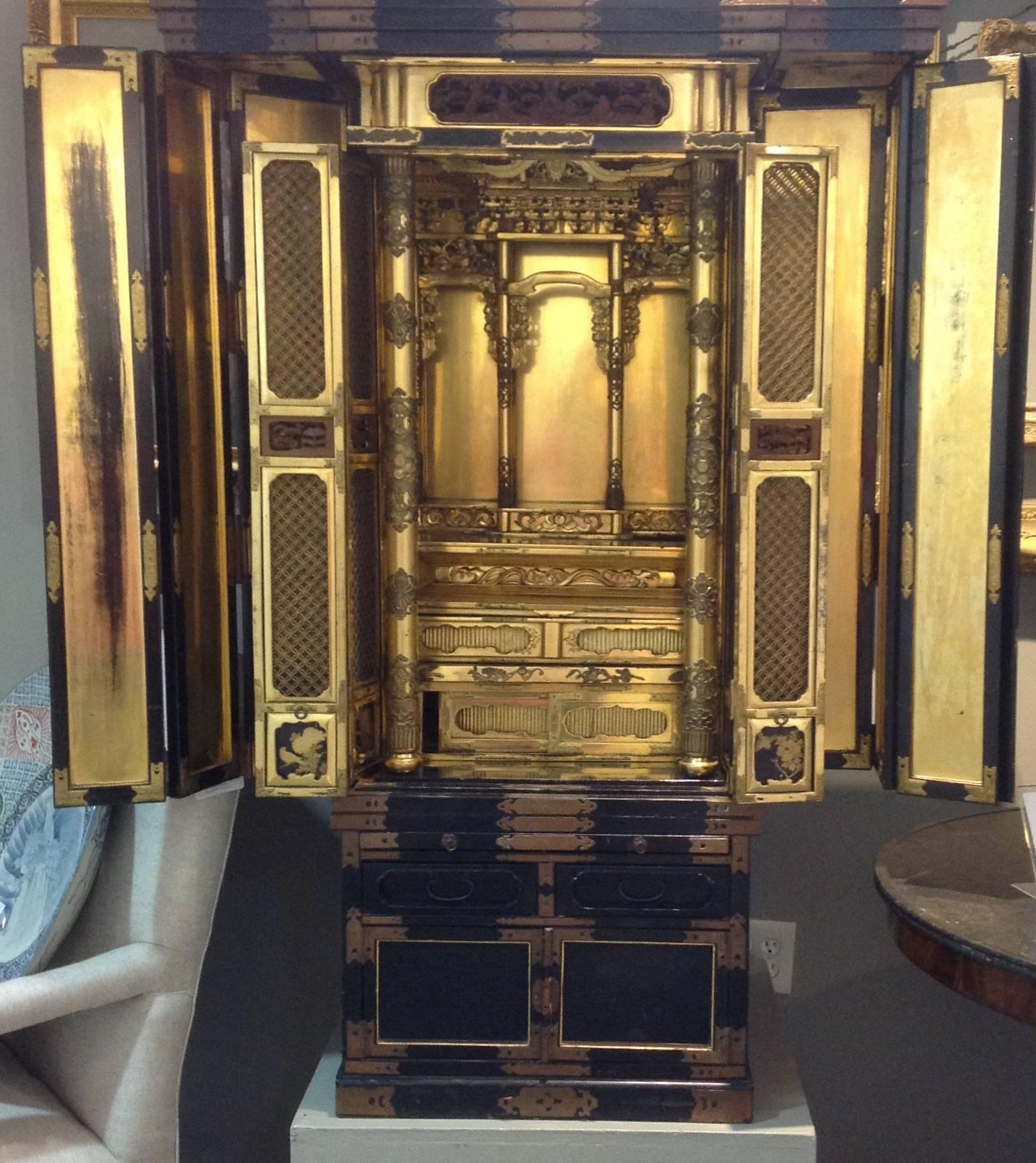 Antique Japanese lacquer Butsudan which is a home altar or shrine with heavily gilded interior, circa 19th century. Two sets of doors fold open to reveal an elaborate gilded fitted interior.
Butsudan