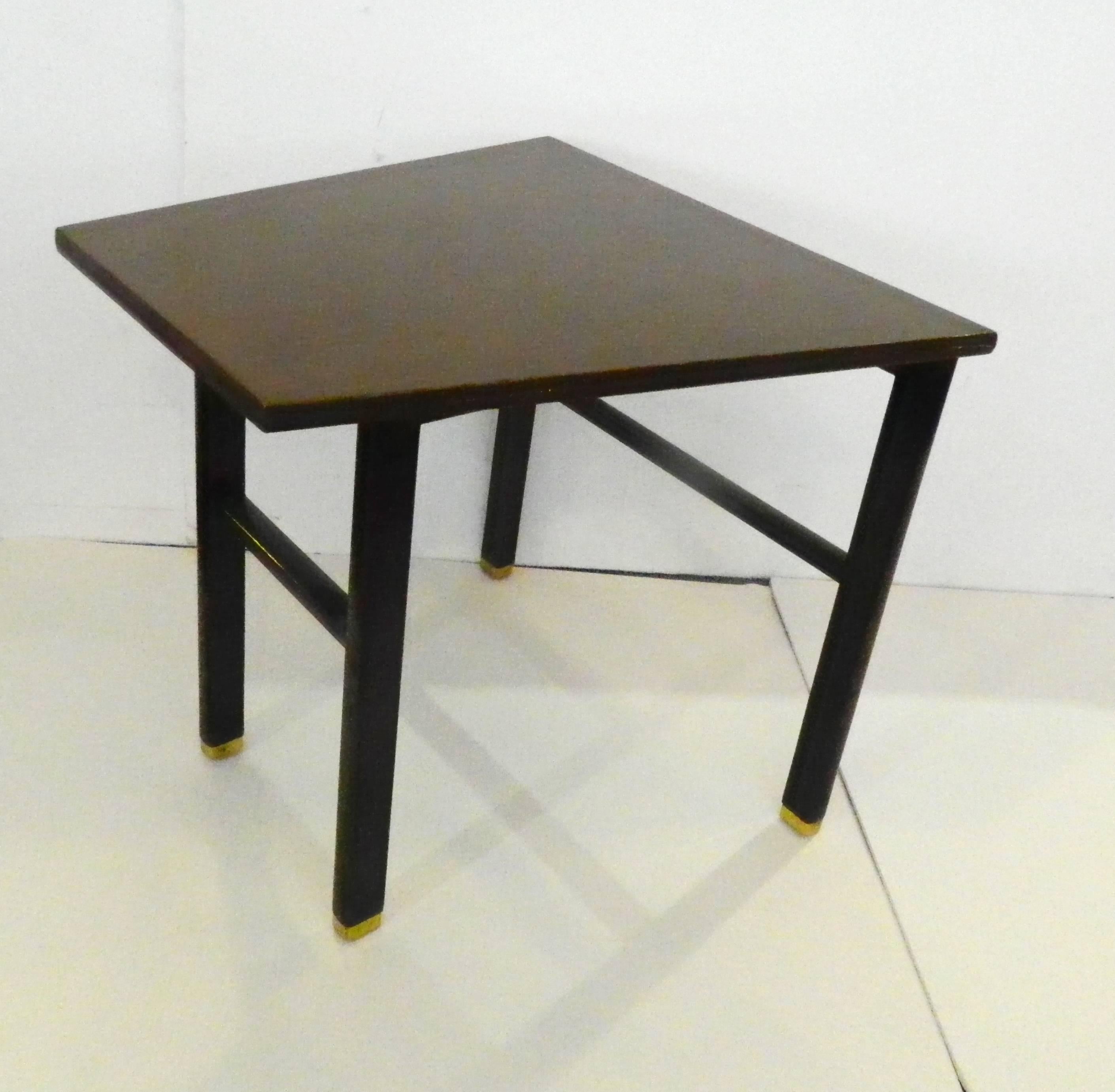 Modern Wedge occasional table designed by Wormley for Dunbar in a trapezoidal shape with brass capped legs. 
The back is 24" wide and tapers to 14". Metal Dunbar label.
