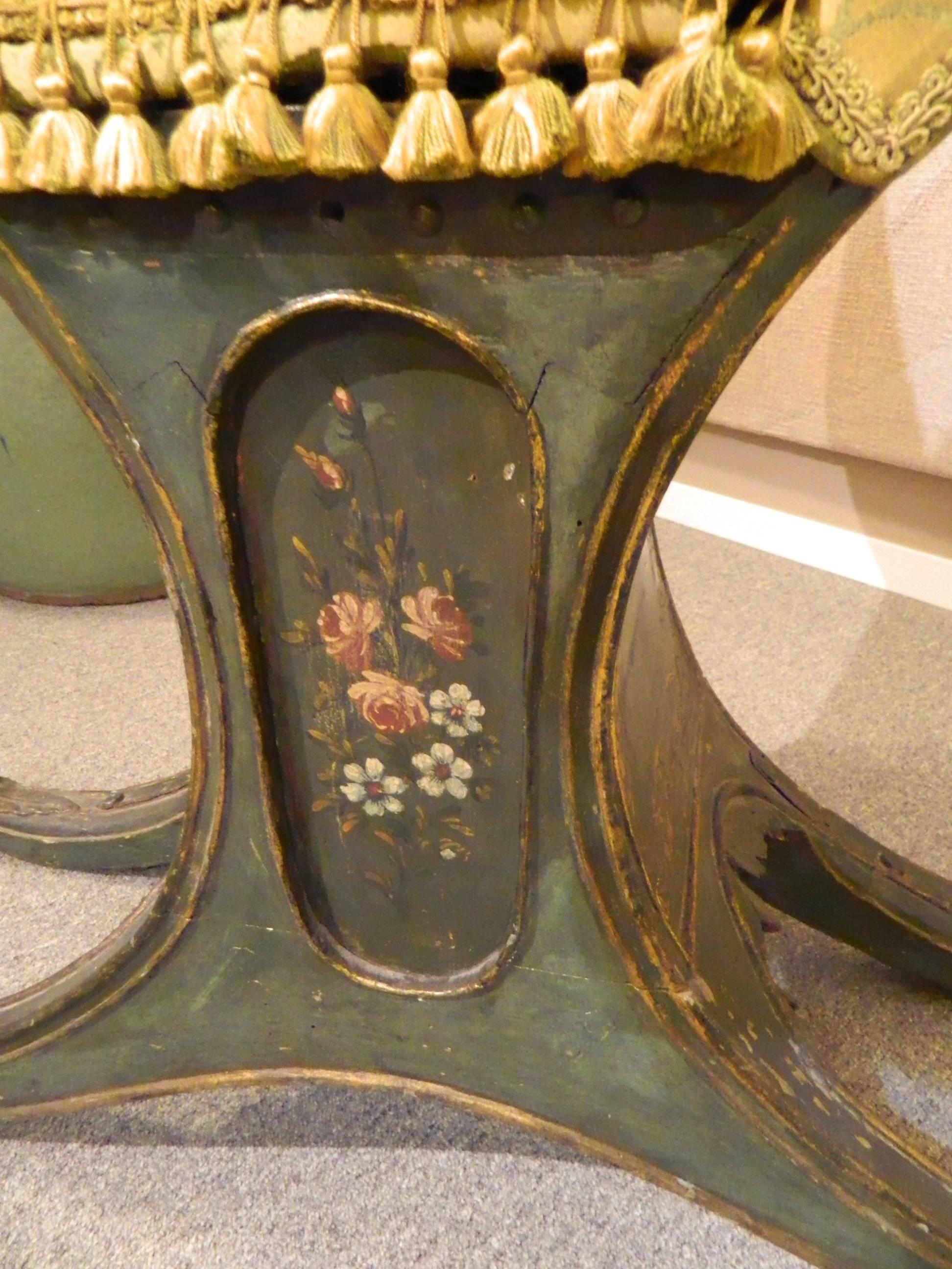Rare Venetian antique gondola child's chair painted with flowers and a lion on the back. It is upholstered in a silk damask. The small size makes this a good accent piece with a 10