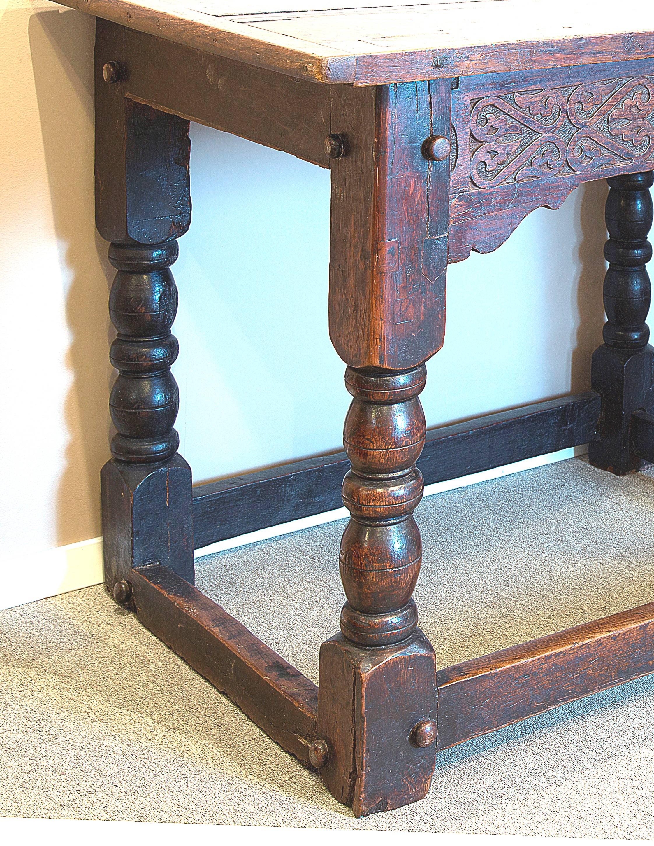 Large 17th century oak refectory table with the date 1692 in the carved detail on the frieze. It has turned leg, a stretcher base and old original finish. 

 