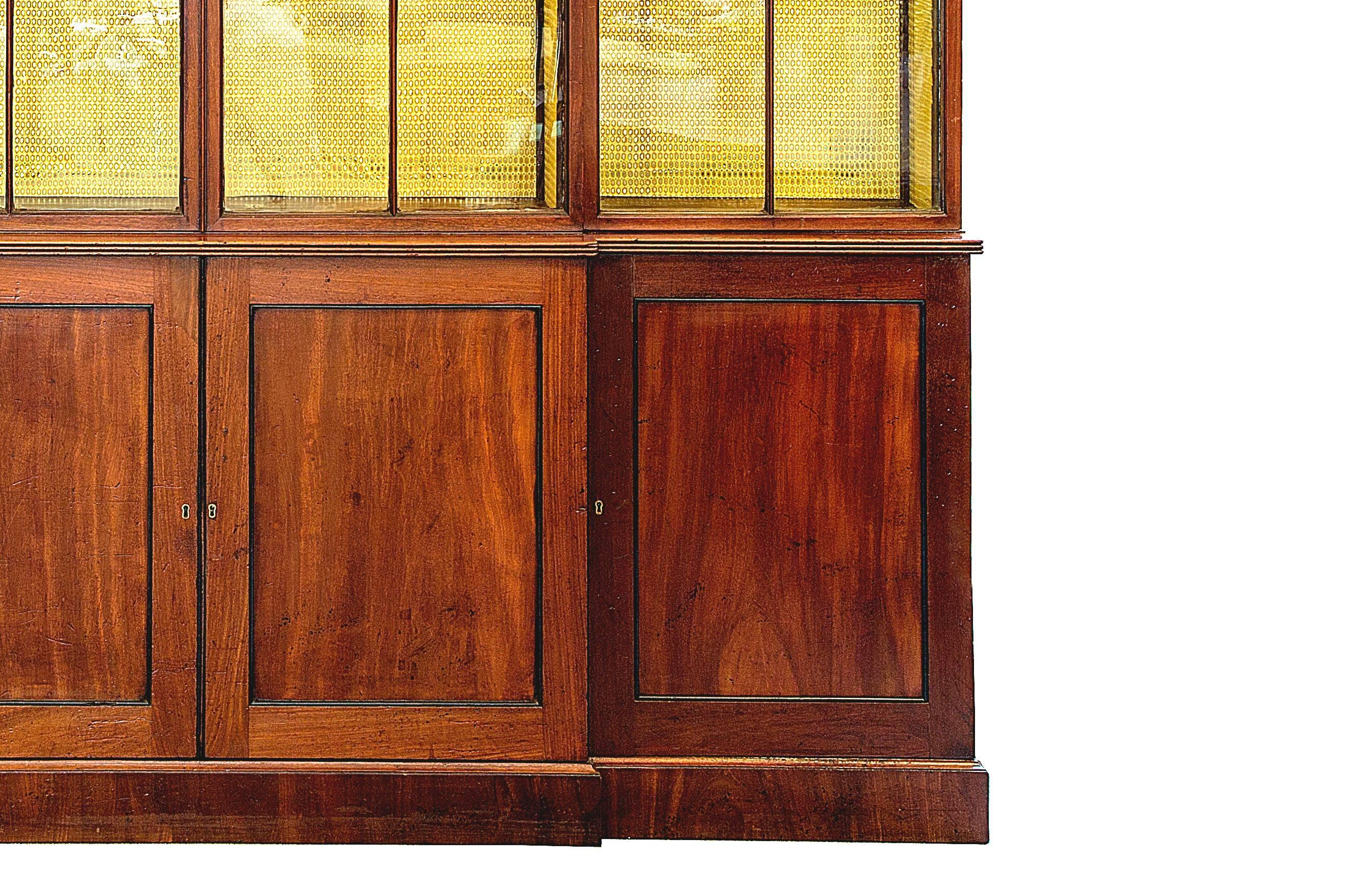 Classic English George III mahogany breakfront with clean lines and great vertical proportions. It is in great antique condition with most original glass.