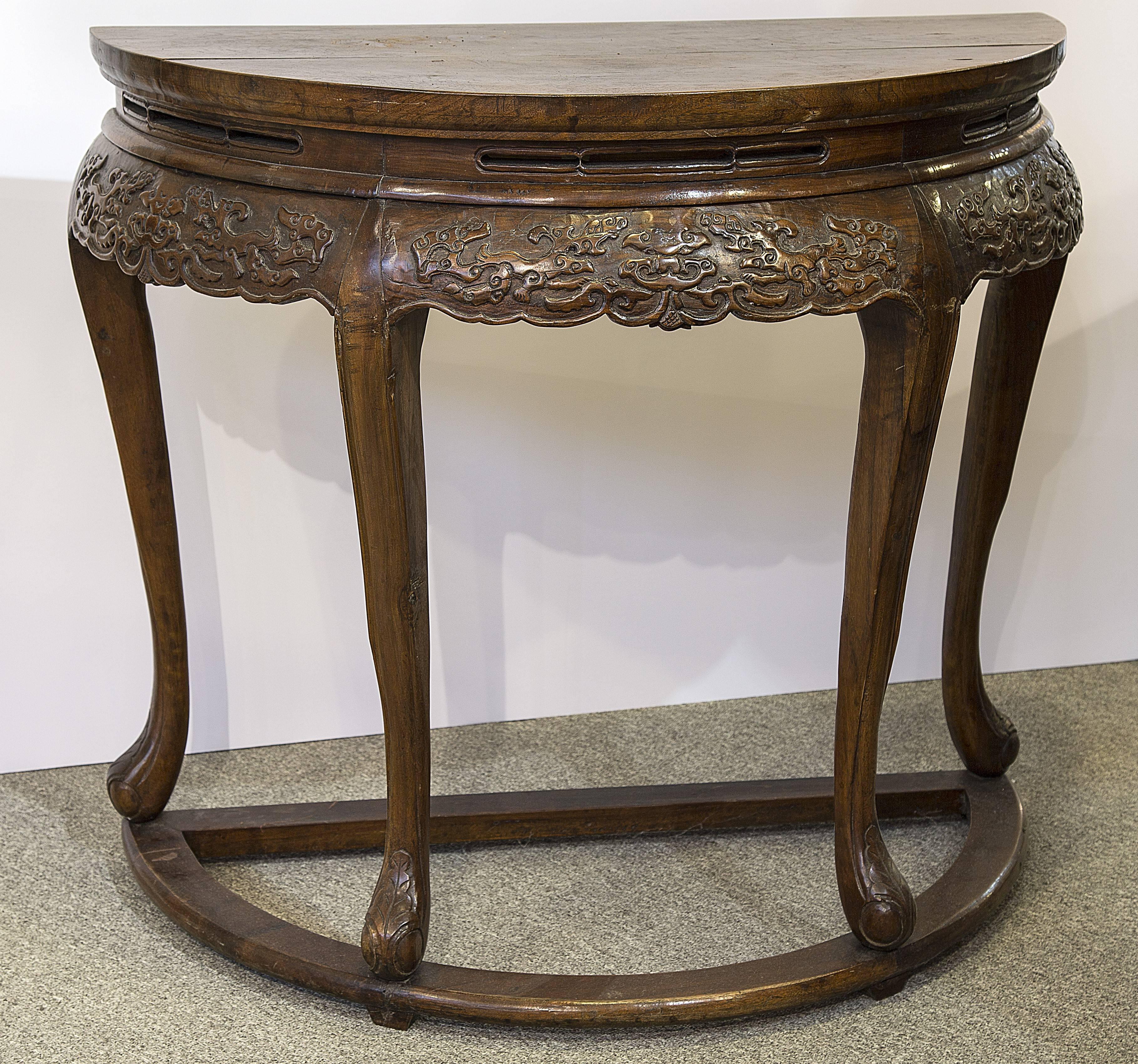 Matched pair of demilune or king tables with cabriole legs and a confronting dragons apron. The consoles fir together to make a 35 inch round center table. One handmade console is 17.5 inches deep and the other is 17.75 inch deep. The wood is most