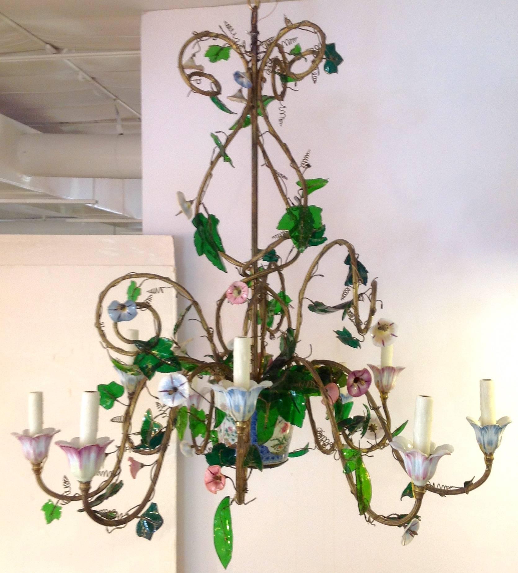 Austrian chandelier attributed to Lobmeyr with painted on opaline flowers, gilt painted green glass leaves and nine brass vine shaped arms. The flower pot base is a 19th century Chinese polychromed cache pot. Circa 1850-1875.