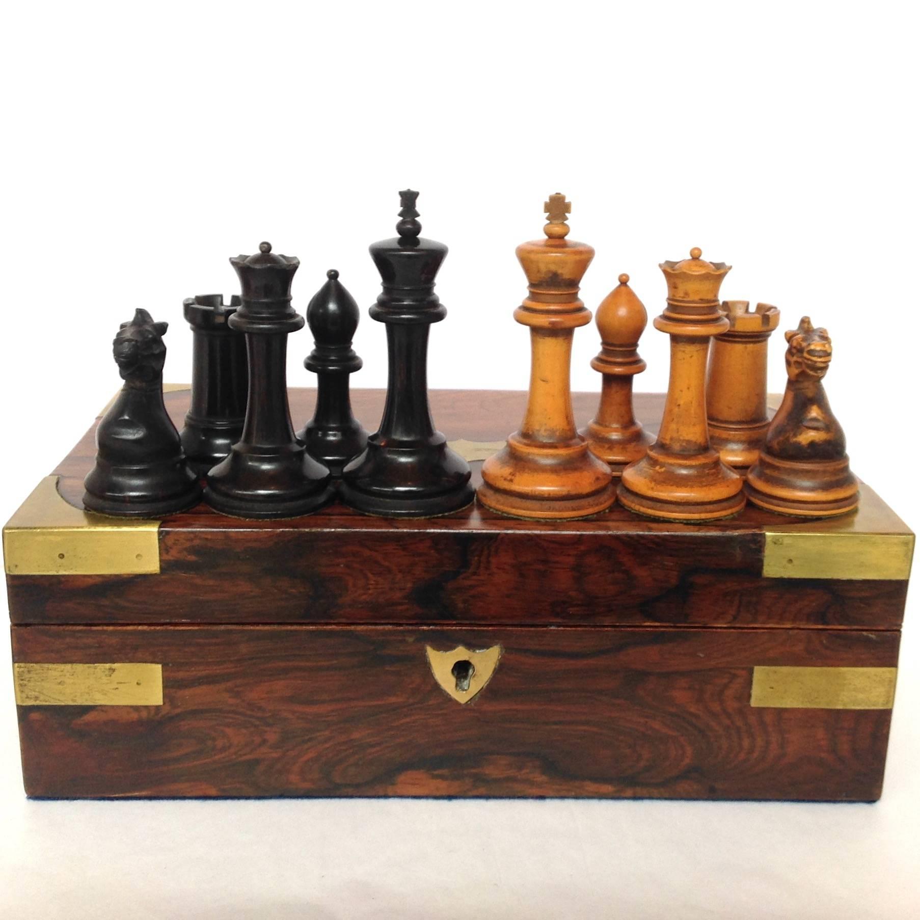 Antique Staunton chess set with boxwood and ebony pieces in rosewood box with brass corners and fittings. The king measures 3.375