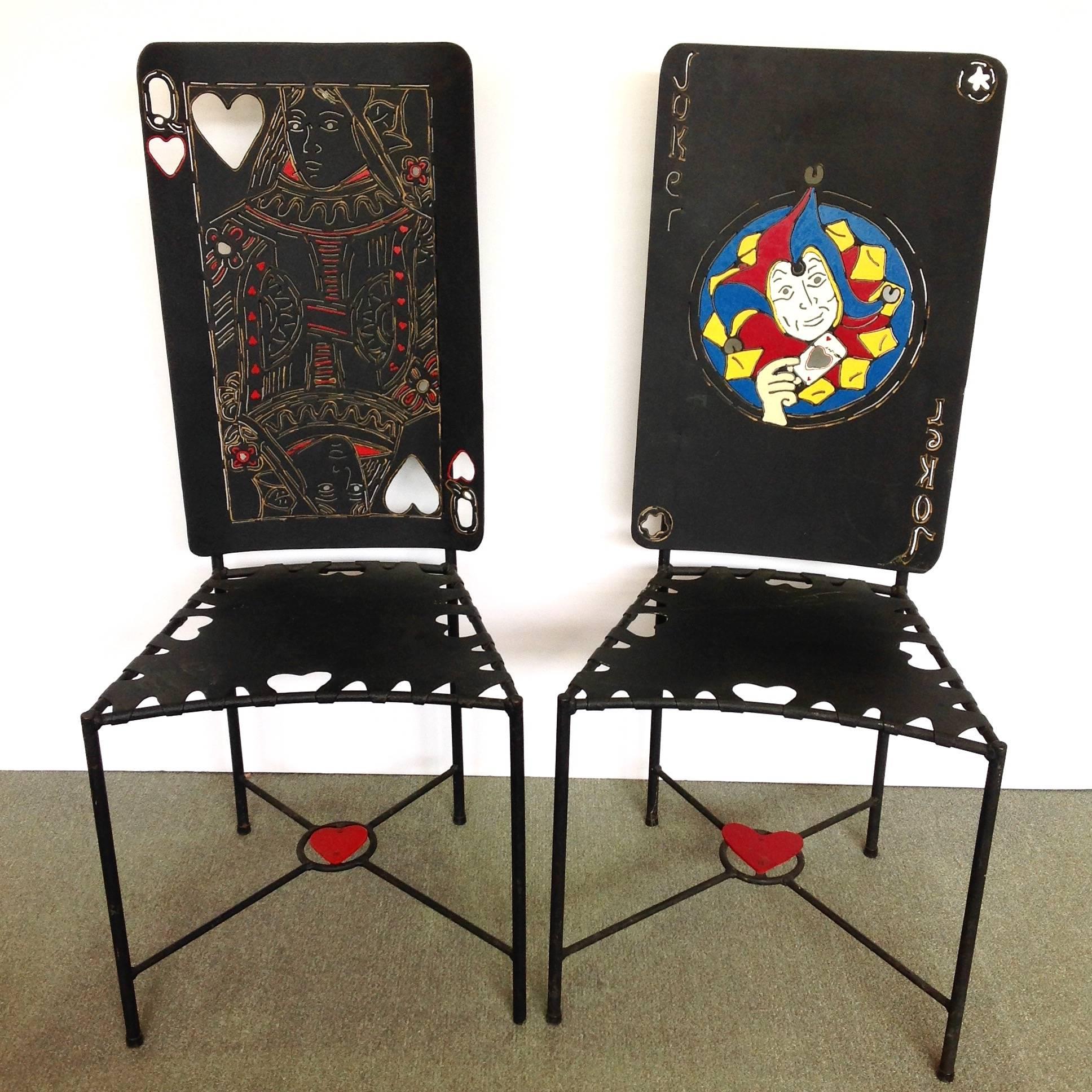 Handmade playing card iron chairs by Ries Niemi, depicting the Queen of Hearts and Joker. The design is both painted and pierced. Niemi worked in Bellingham, Washington in the 20th century.