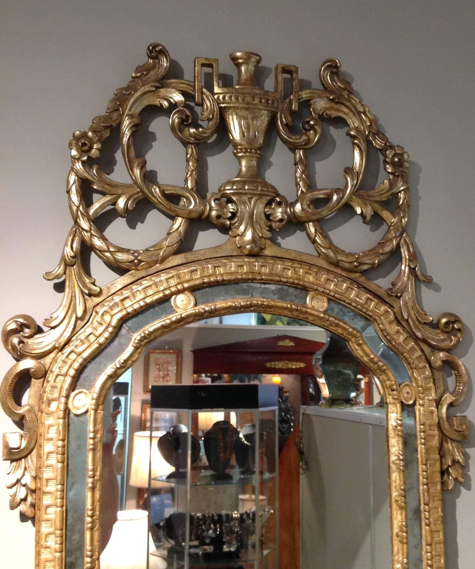 Antique Continental openwork carved wood and gilt mirror. Circa late 18th or early 19th century.