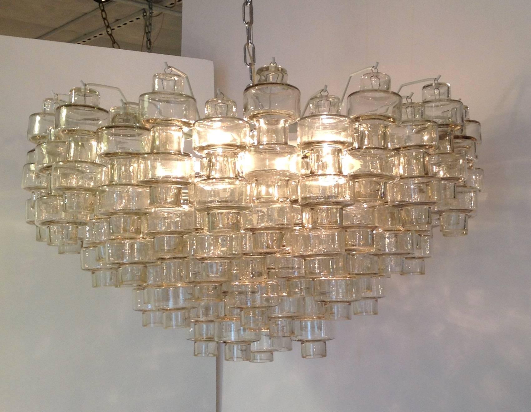 Large clear glass Murano round chandelier that could be flush mounted. Each barbell shaped glass pendant is clear. It has 4 light sockets. It has a white frame. Made in Italy in the 1960s.