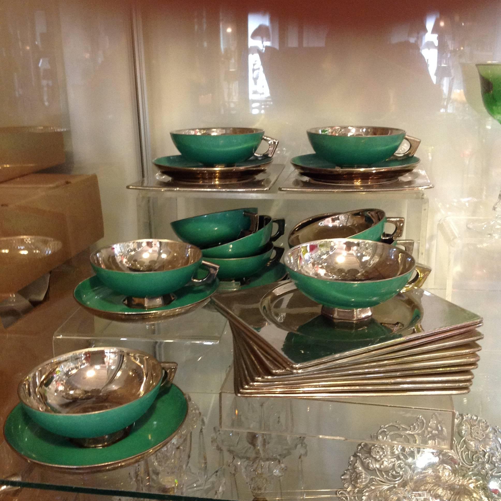 Rare Art Deco luncheon set in brilliant silver and jade green by Jean Luce, the important French ceramicist. It is designed for the pieces to nest. The set has a crème color ceramic base with a metallic silver finish and jade green on the cups and