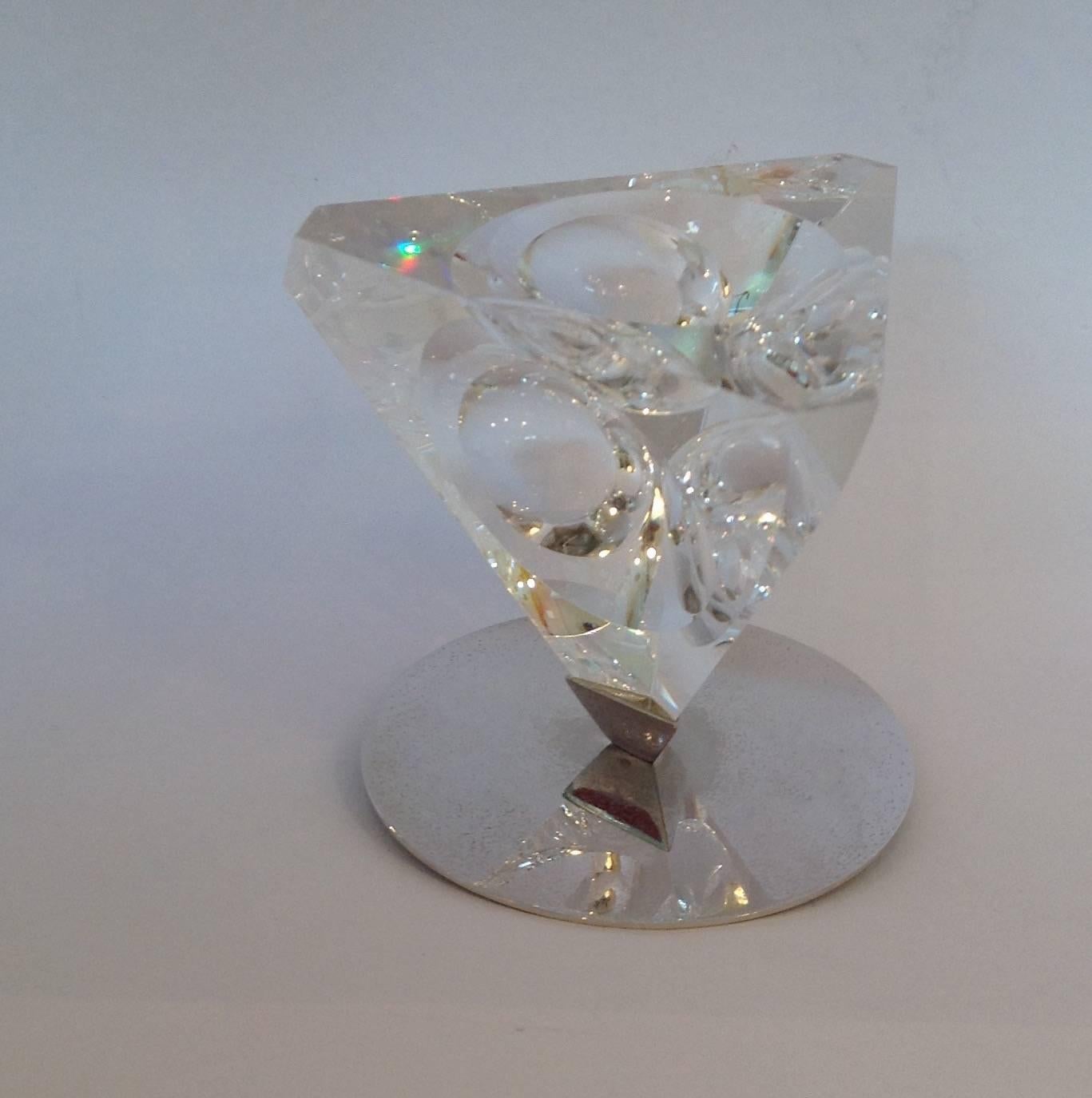 Steuben clear crystal sphere tetra ornament designed by Lloyd Atkins on a silver plated round metal base.