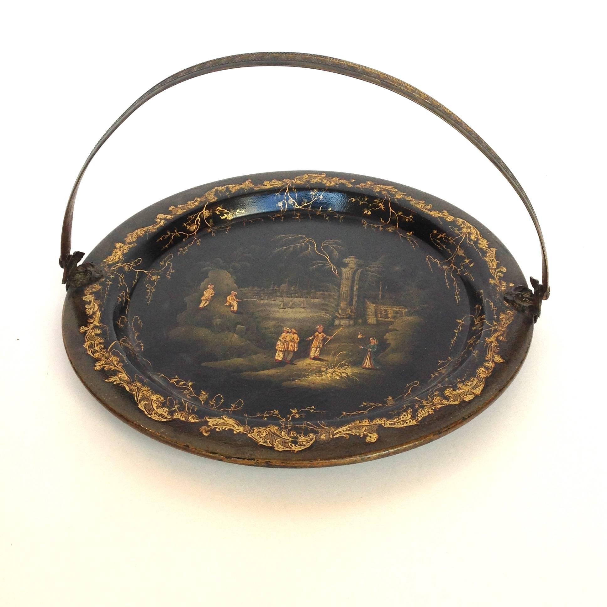Antique English black papier mâché tray with chinoiserie gilt decoration and a metal swing handle. There is an impressed mark on bottom Clay, King St. Covt Garden, circa early 19th century.
Henry Clay of Birmingham set up his papier mâché business