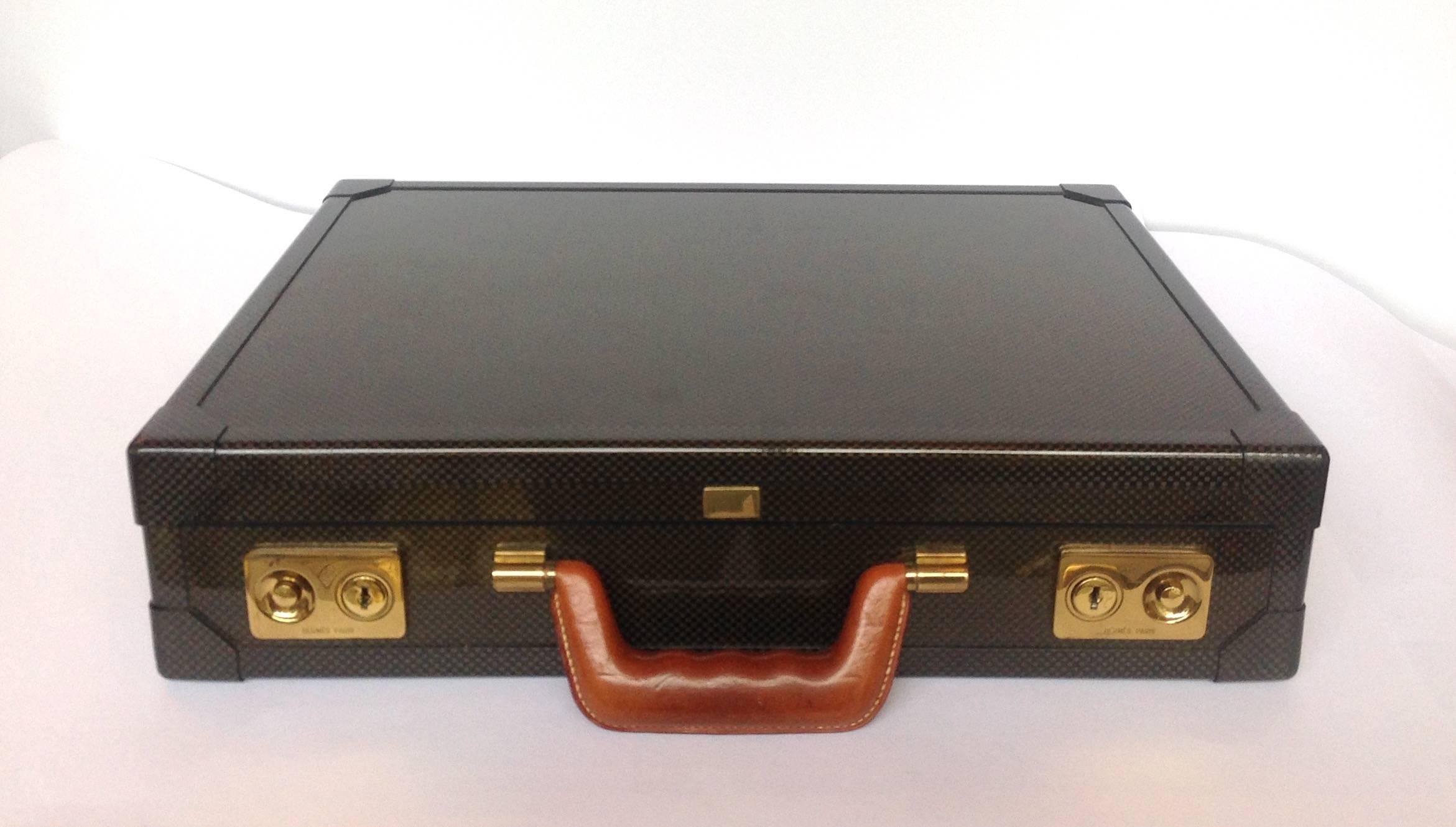Hermes limited edition graphite attache brief case with 18-karat gold-plated hardware. The original retail price was $16,900. This was from a limited edition of 500 in 2008. It is constructed of a sleek graphite carbon fiber with an understated