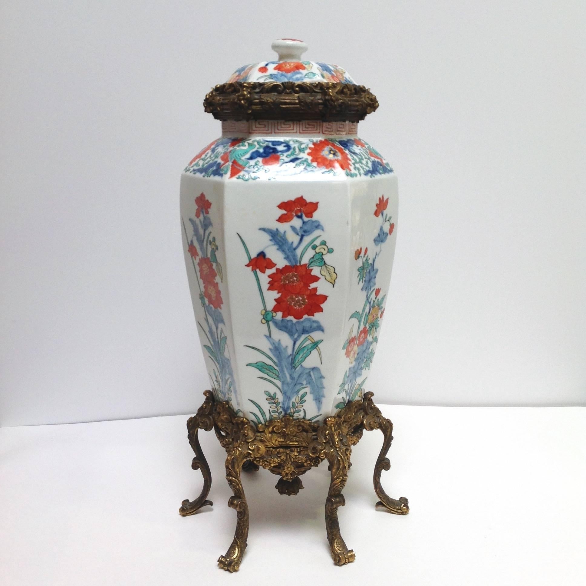 Sampson covered porcelain vase with ornate French gilt bronze mounts. The vase has an Asian inspired blue and orange floral decoration with a Greek key pattern along the top. 
Paris, France.  Circa early 19th century.