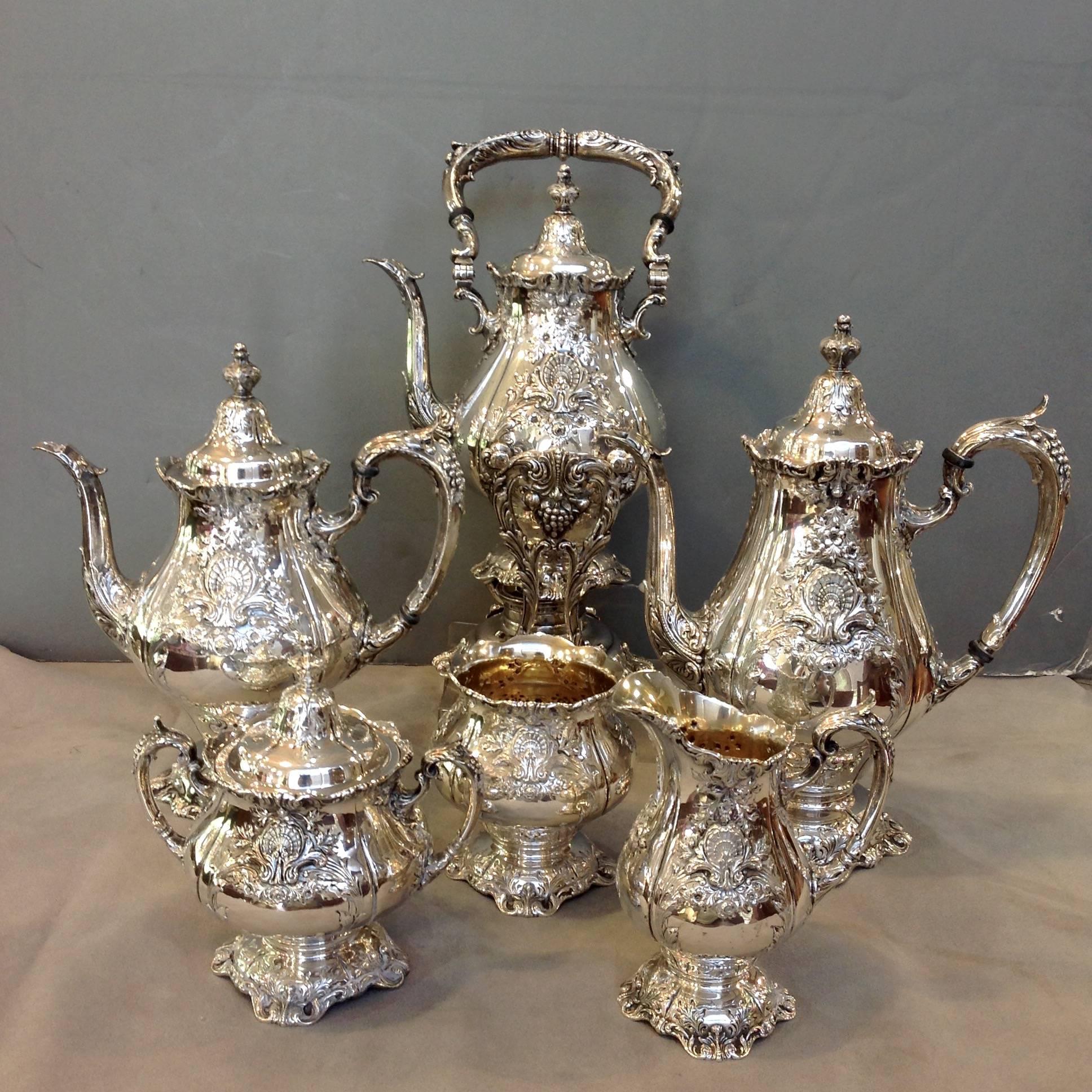 Sir Christopher six-piece sterling tea set including a kettle on stand and a large two handled oval tray. It is monogrammed G. This beautiful set is hand chased and quite heavy. It was made by Wallace in the 1960s.