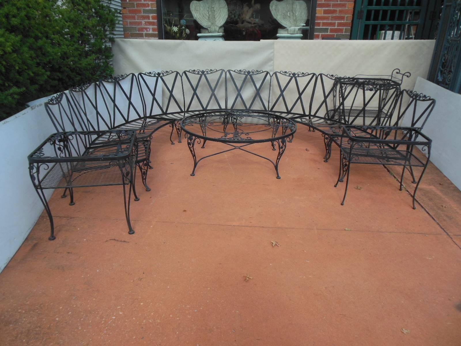 This is an extensive garden patio set by Woodard in the most desirable Chantilly Rose Pattern. The wrought iron set was made in the mid 20th century.
The large set consists of 6 seating pieces of which 4 are curved half moon shaped loveseats & 2