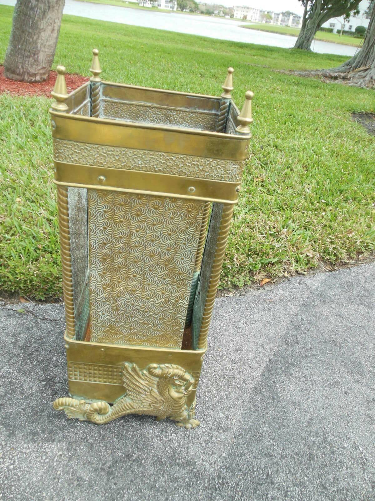 An American aesthetic movement brass umbrella stand. The brass stand with 
two different embossed aesthetic designs. Two sides have a mythological dragon/griffin, the two other sides are plain. Probably polished by a previous owner 20 years or so