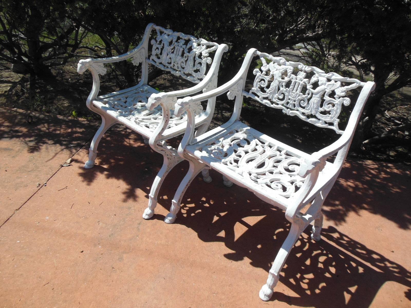 An ornate Pair of Schinkel style Garden Chairs with full figured winged  Angels, the arms 
Terminating in Rams heads, with a pierced carved seats raised on cloven
Hoof feet. The chairs are cast aluminum and identical to the chairs and benches at