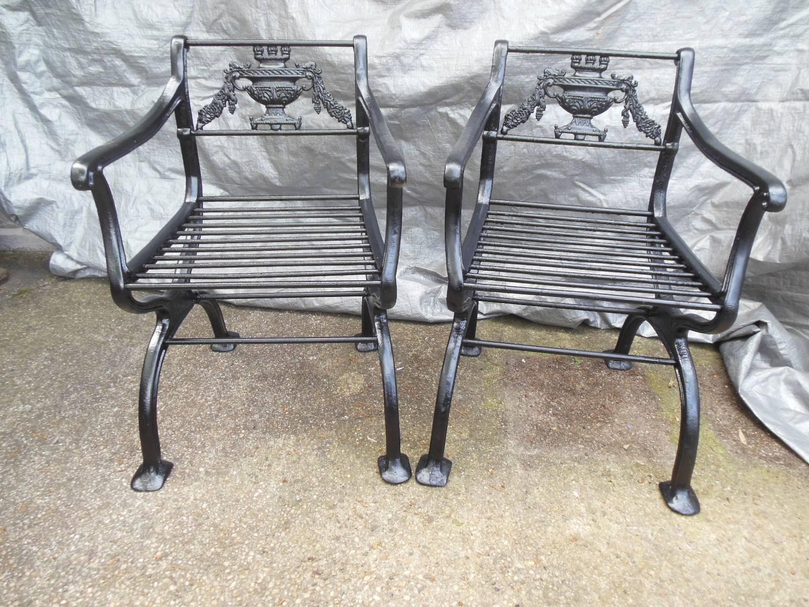 An antique cast iron Regency garden set consisting of a bench and two matching armchairs. The set is inspired by a design circa 1835 by artist Karl Friedrich Schinkel (1781-1841). The armchairs and bench both with rod turned seats. All in excellent